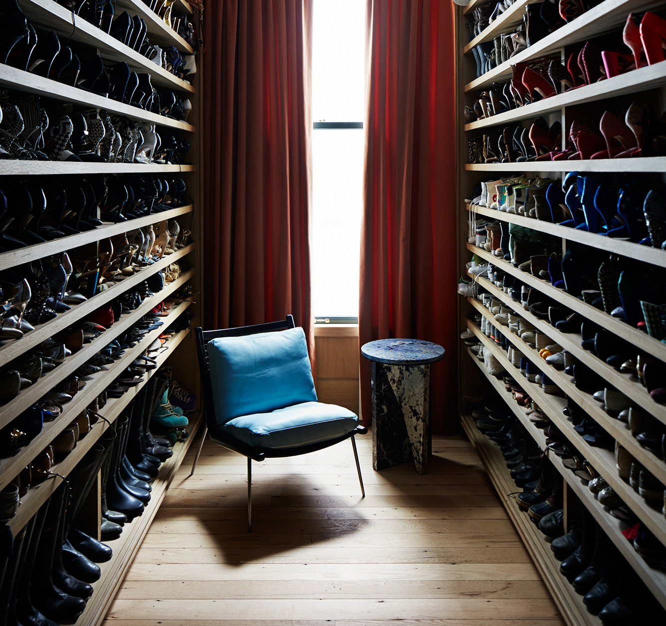a room filled with lots of shoes next to a window