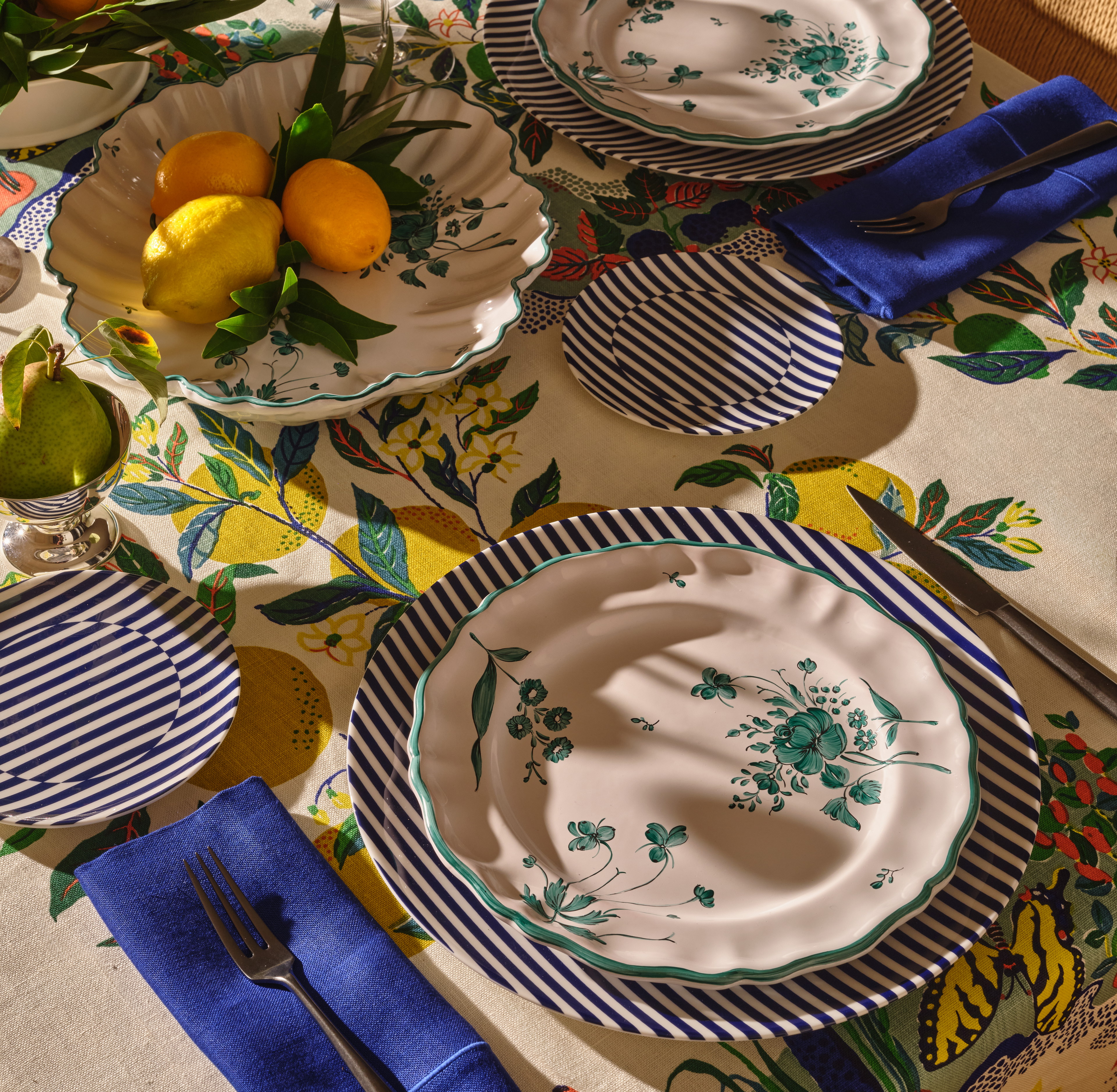 a table topped with plates and bowls filled with fruit
