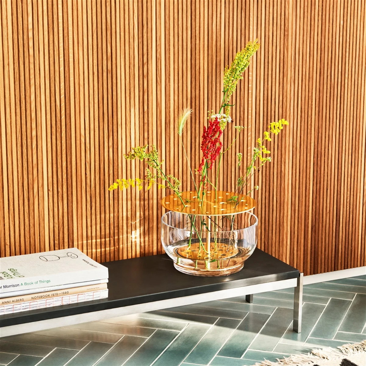 a glass vase with flowers on a table