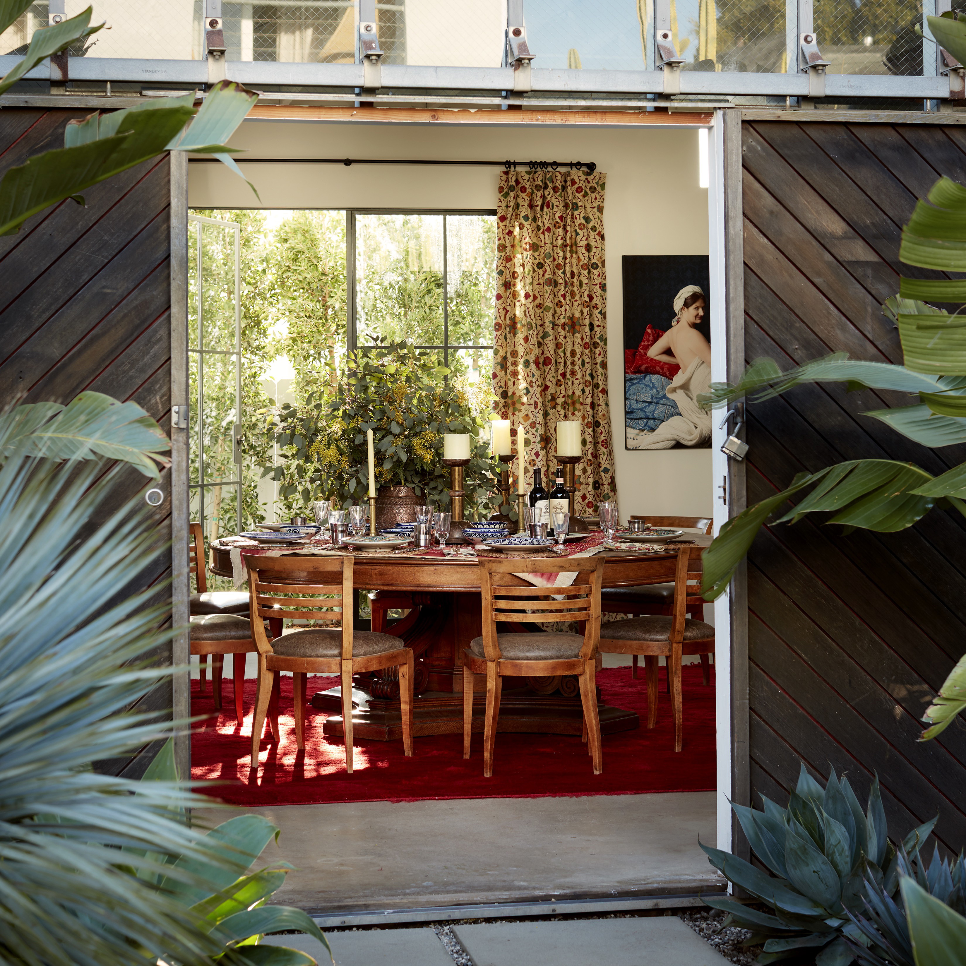 a dining room table and chairs in front of a sliding glass door