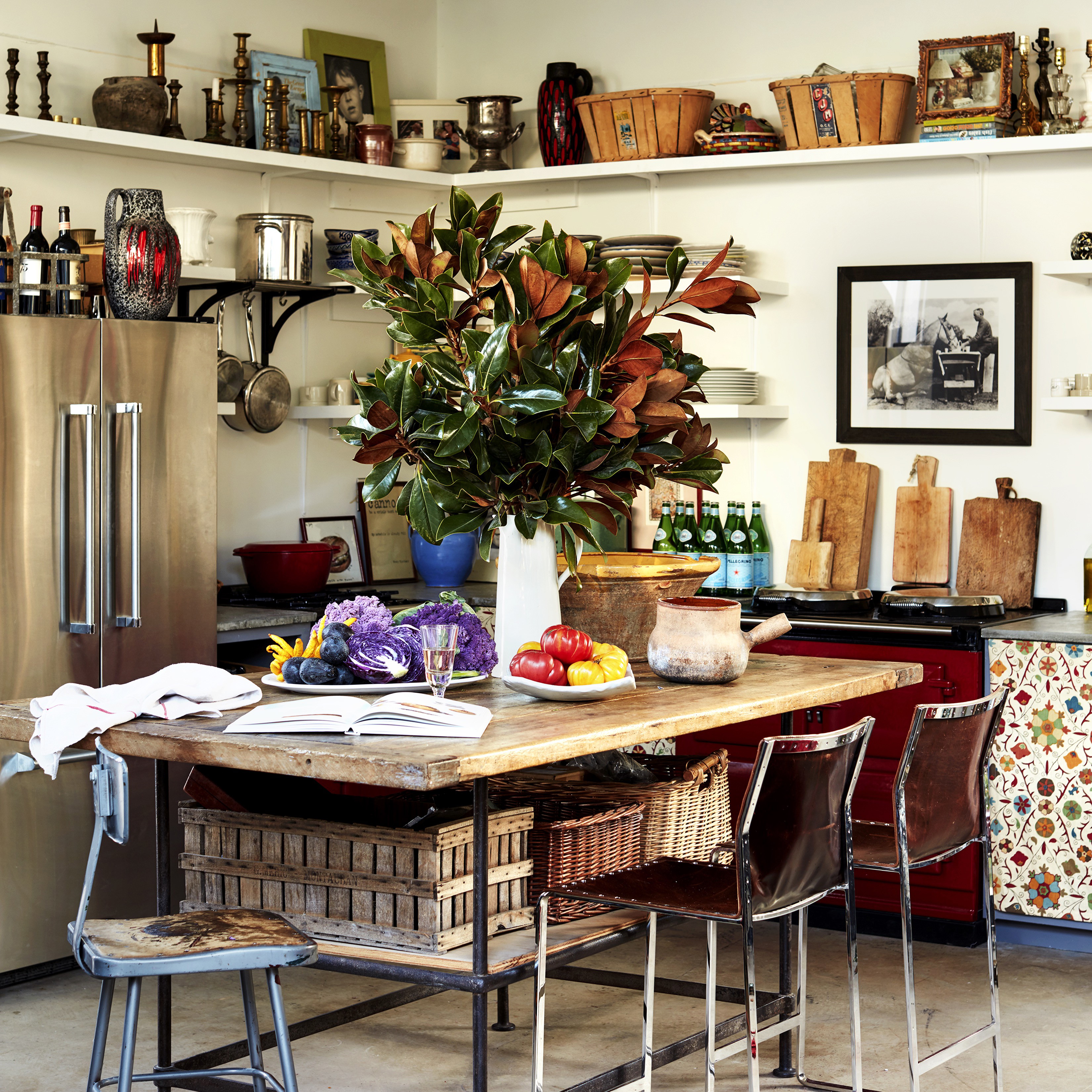 a kitchen with a table, chairs, and a refrigerator