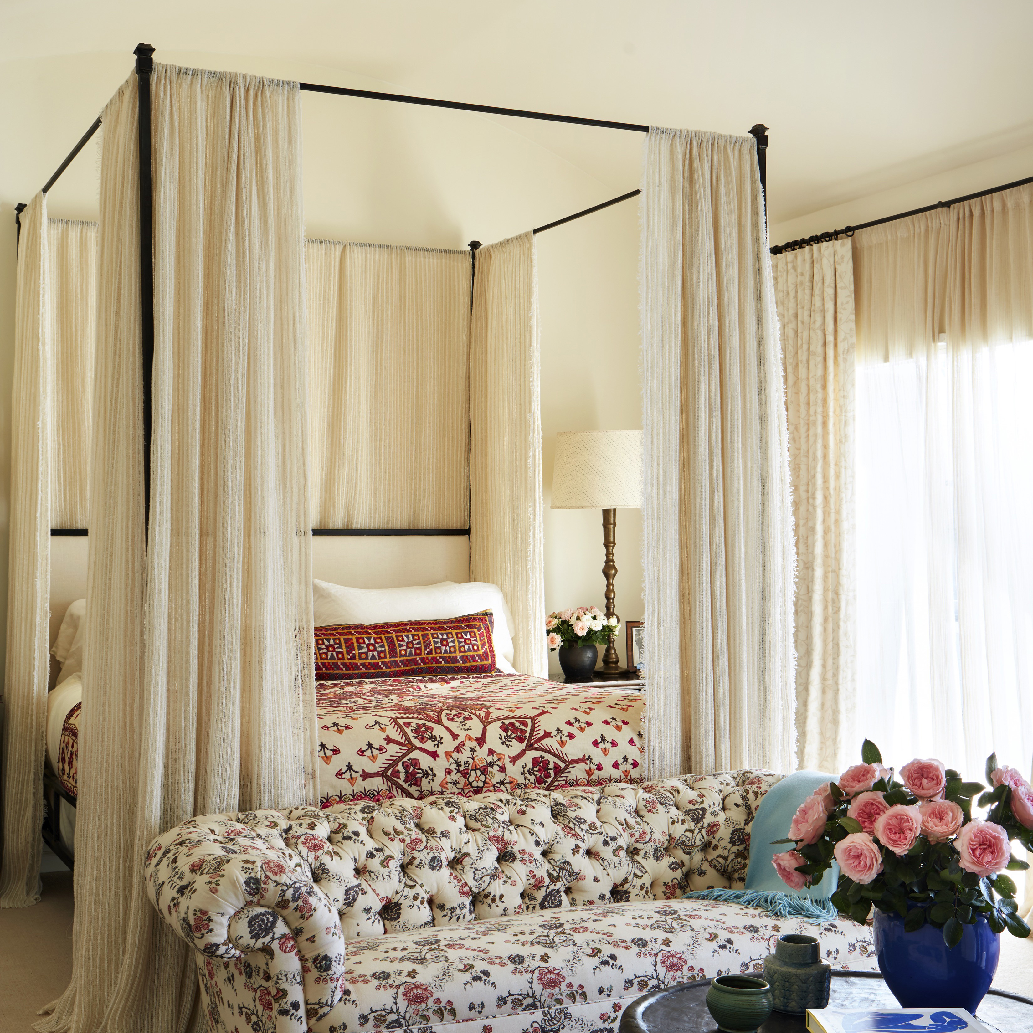 a living room with a couch and a canopy bed