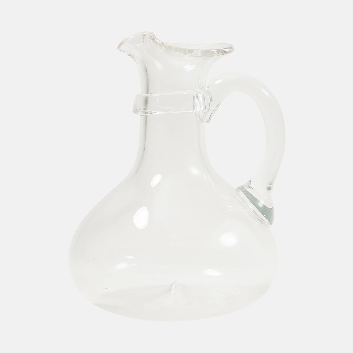 a clear glass vase with a handle on a white background