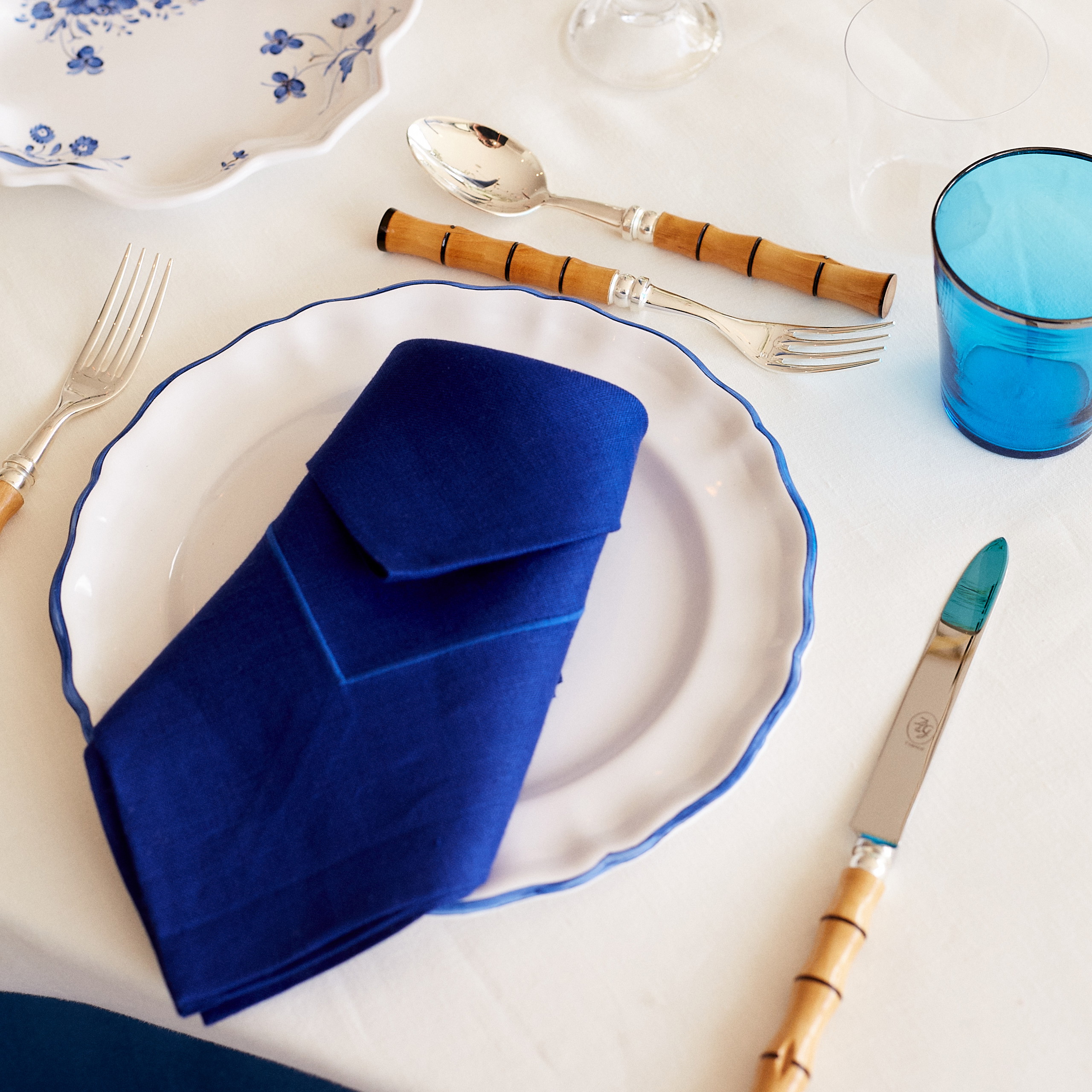 a white table topped with a blue napkin