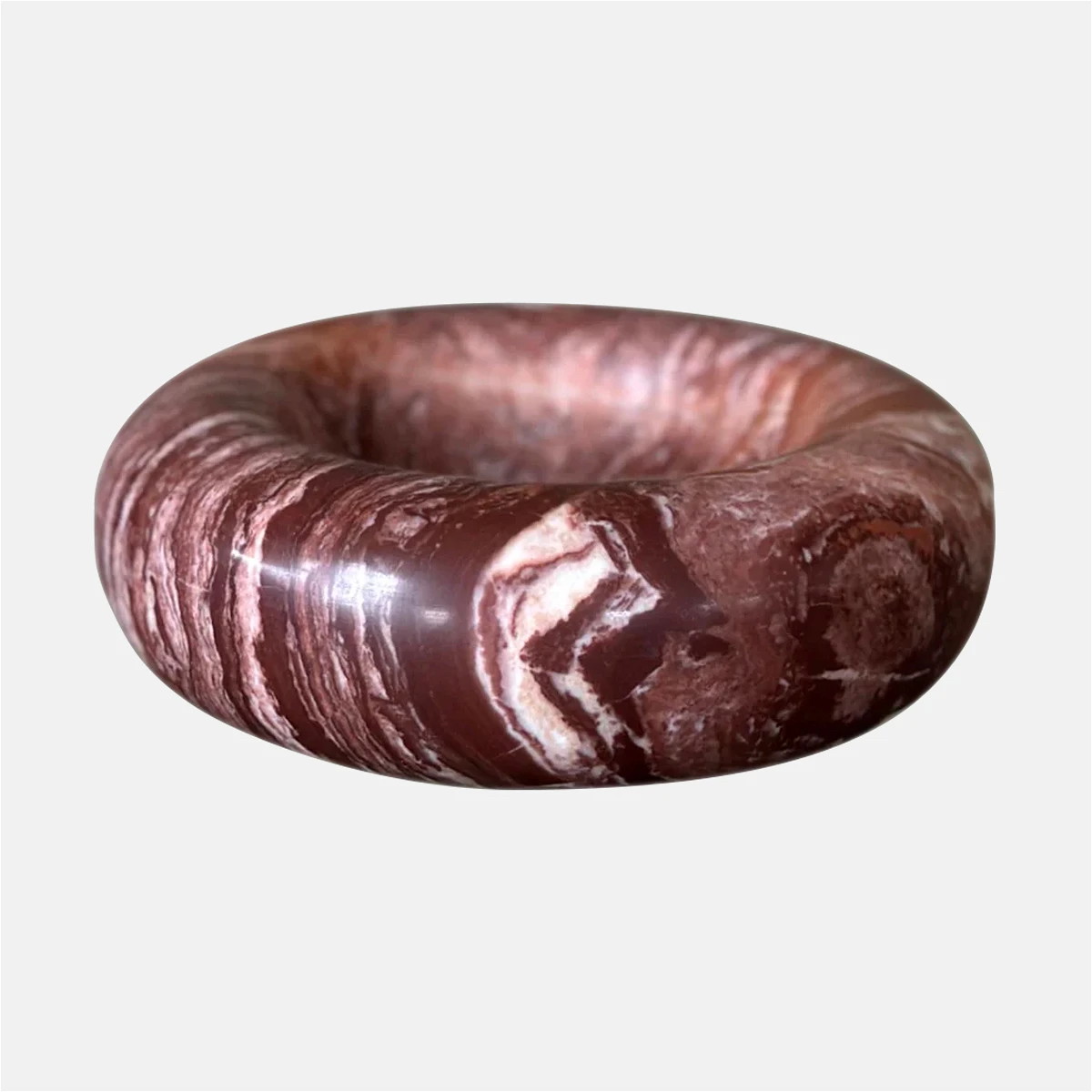 a brown and white marble bracelet on a white background