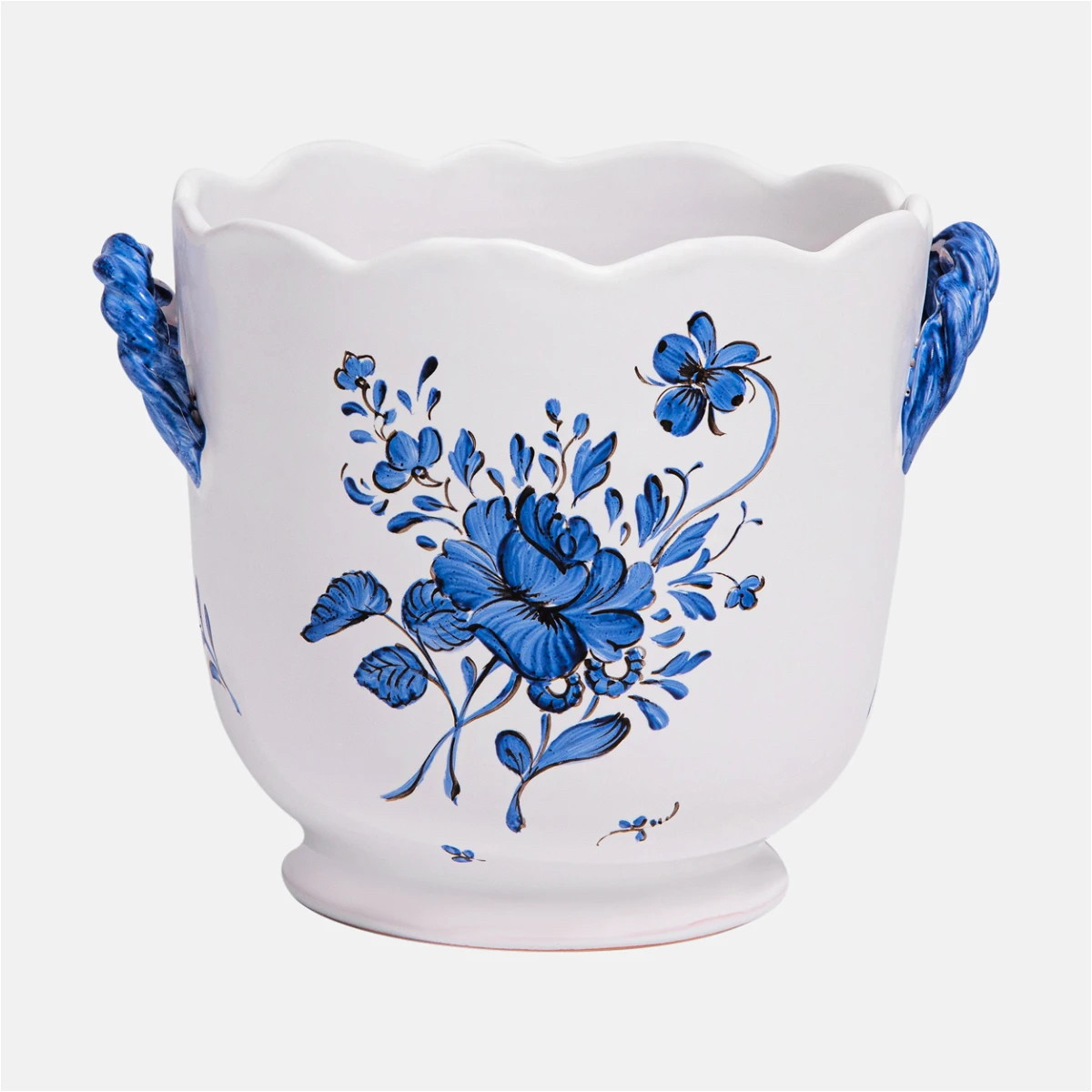 a blue and white vase with flowers painted on it