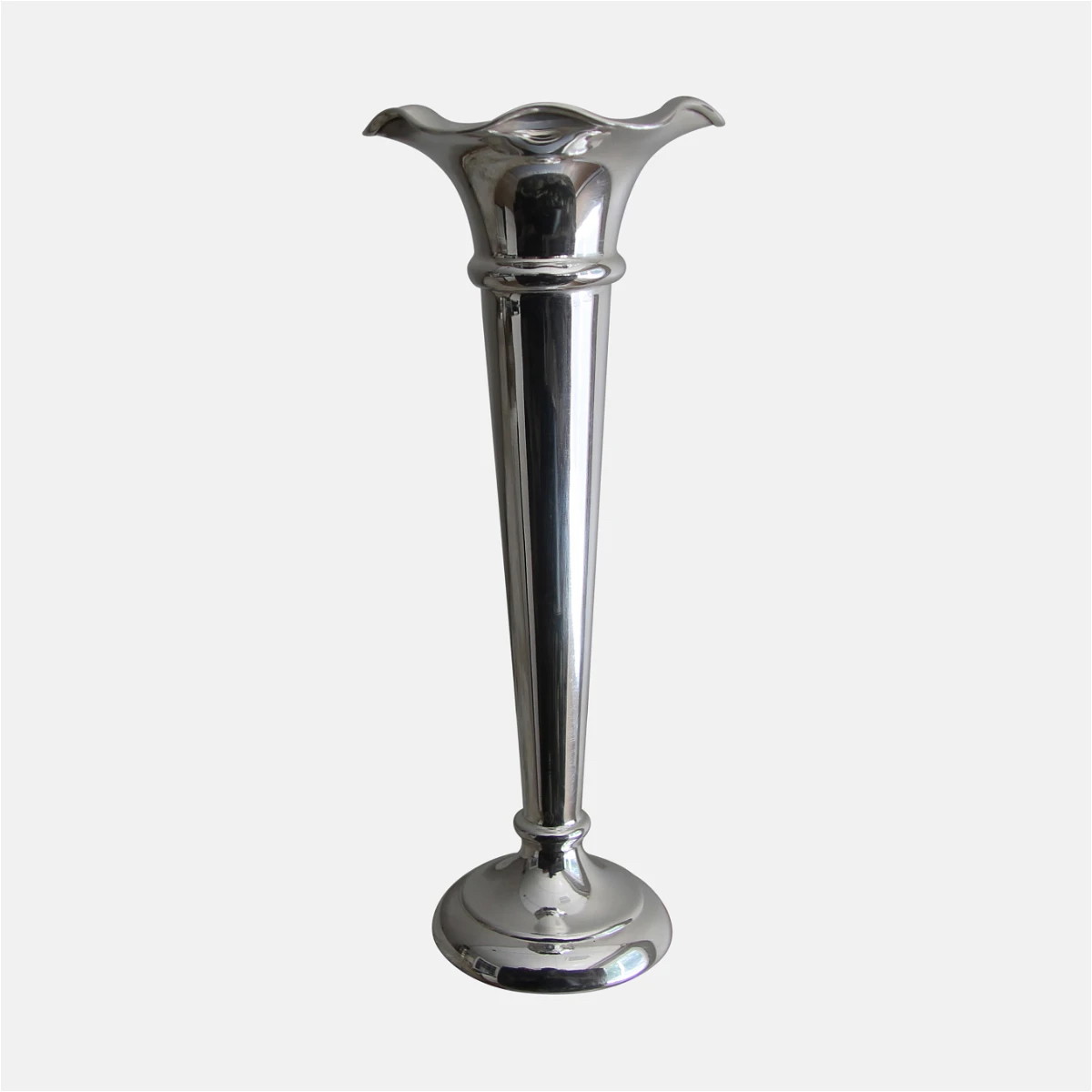 a tall silver vase sitting on top of a table