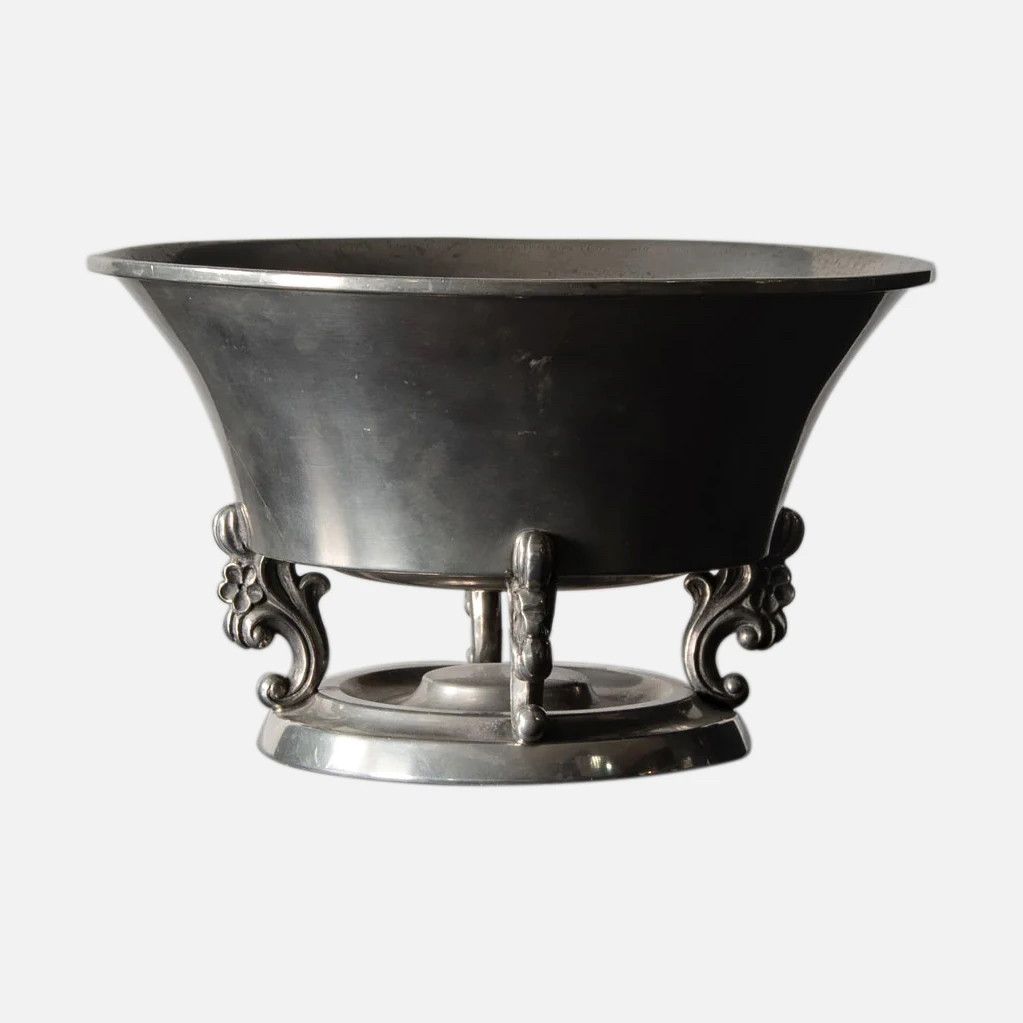 a large metal bowl on a metal stand