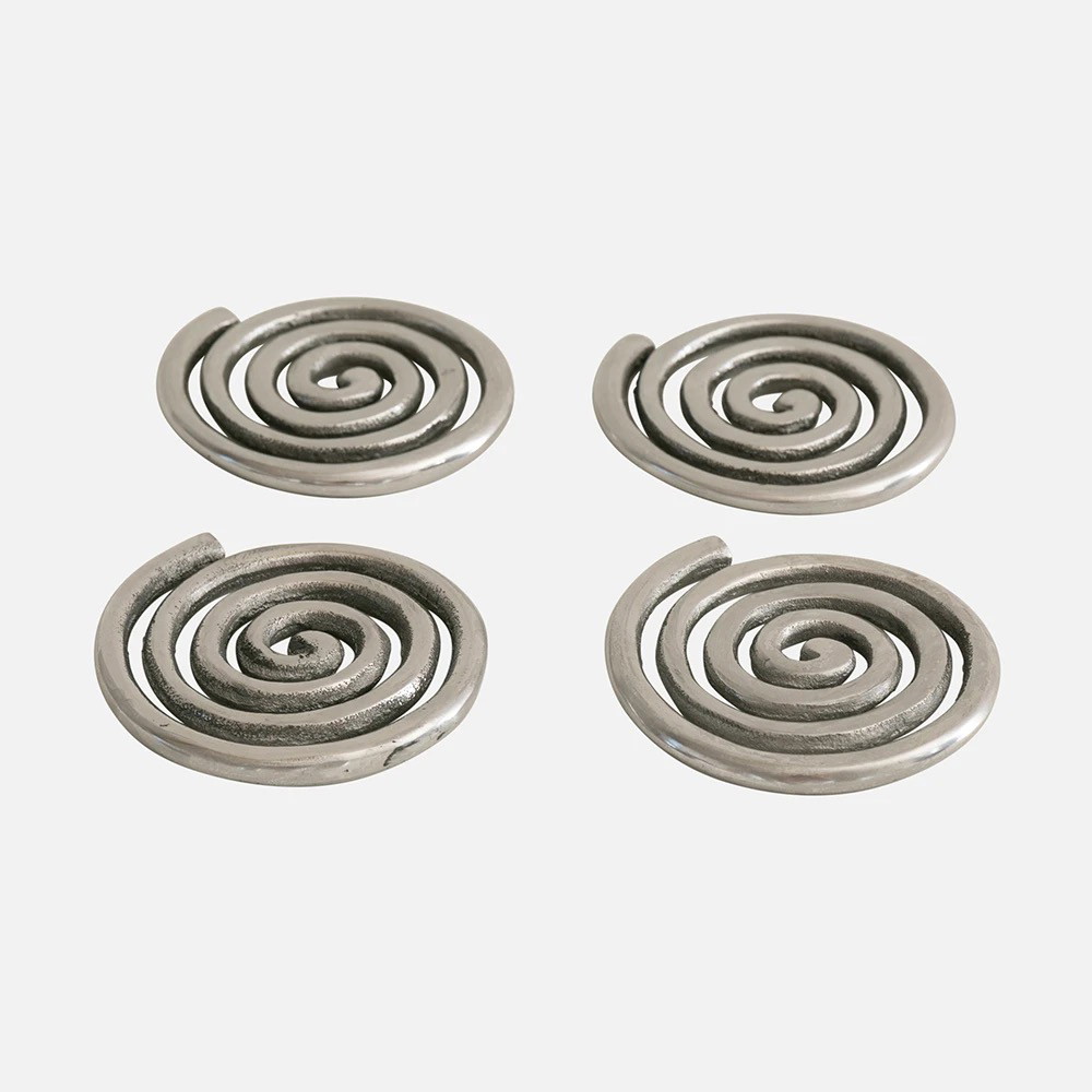 a set of four metal spirals on a white background