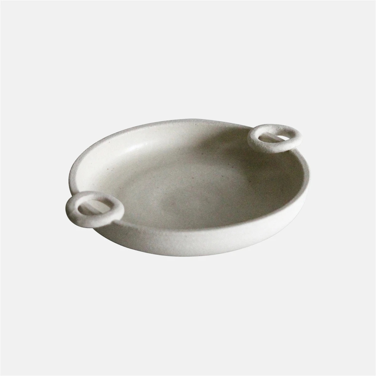 a white bowl with two handles on a white background