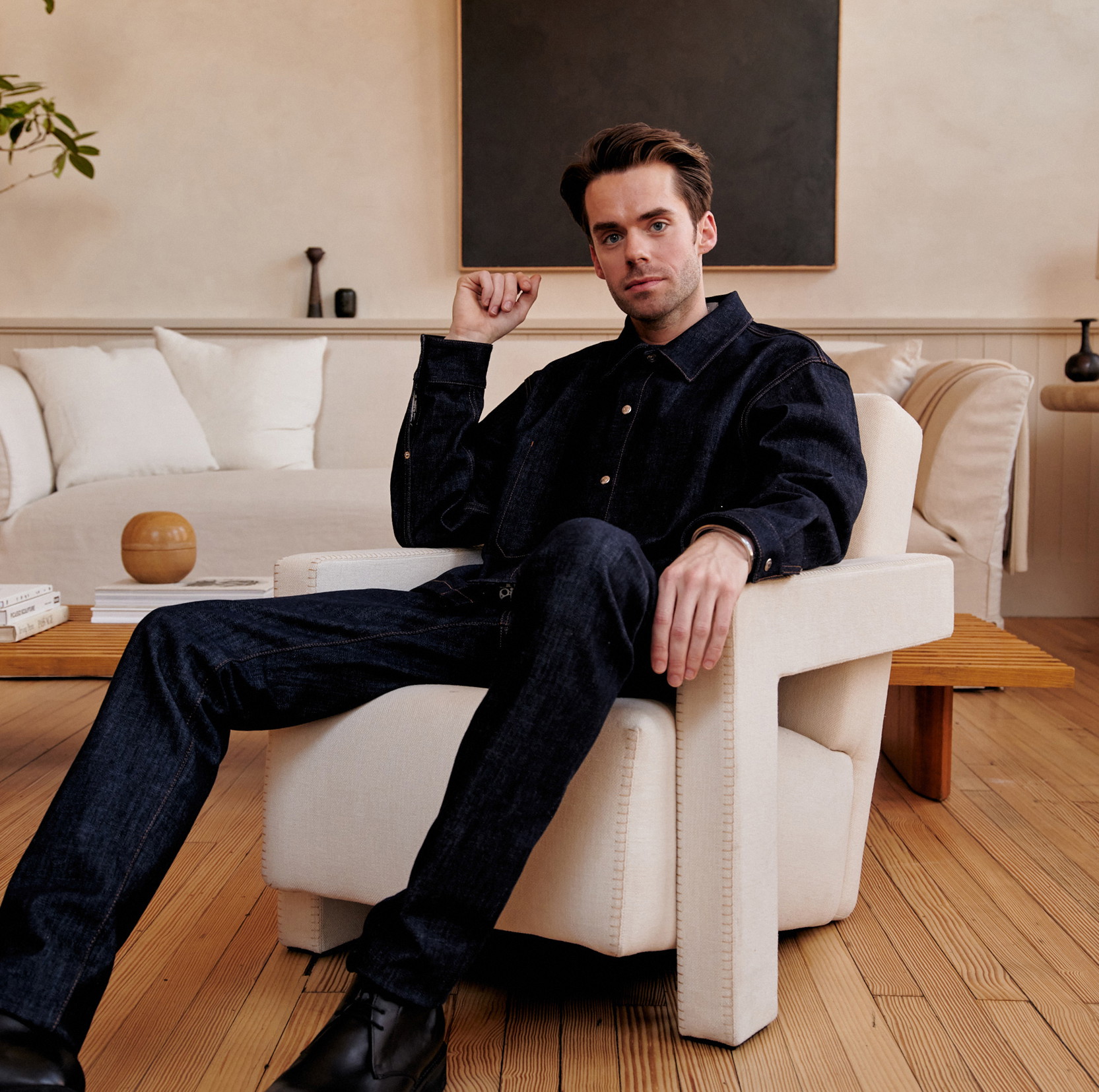 a man sitting on a chair in a living room