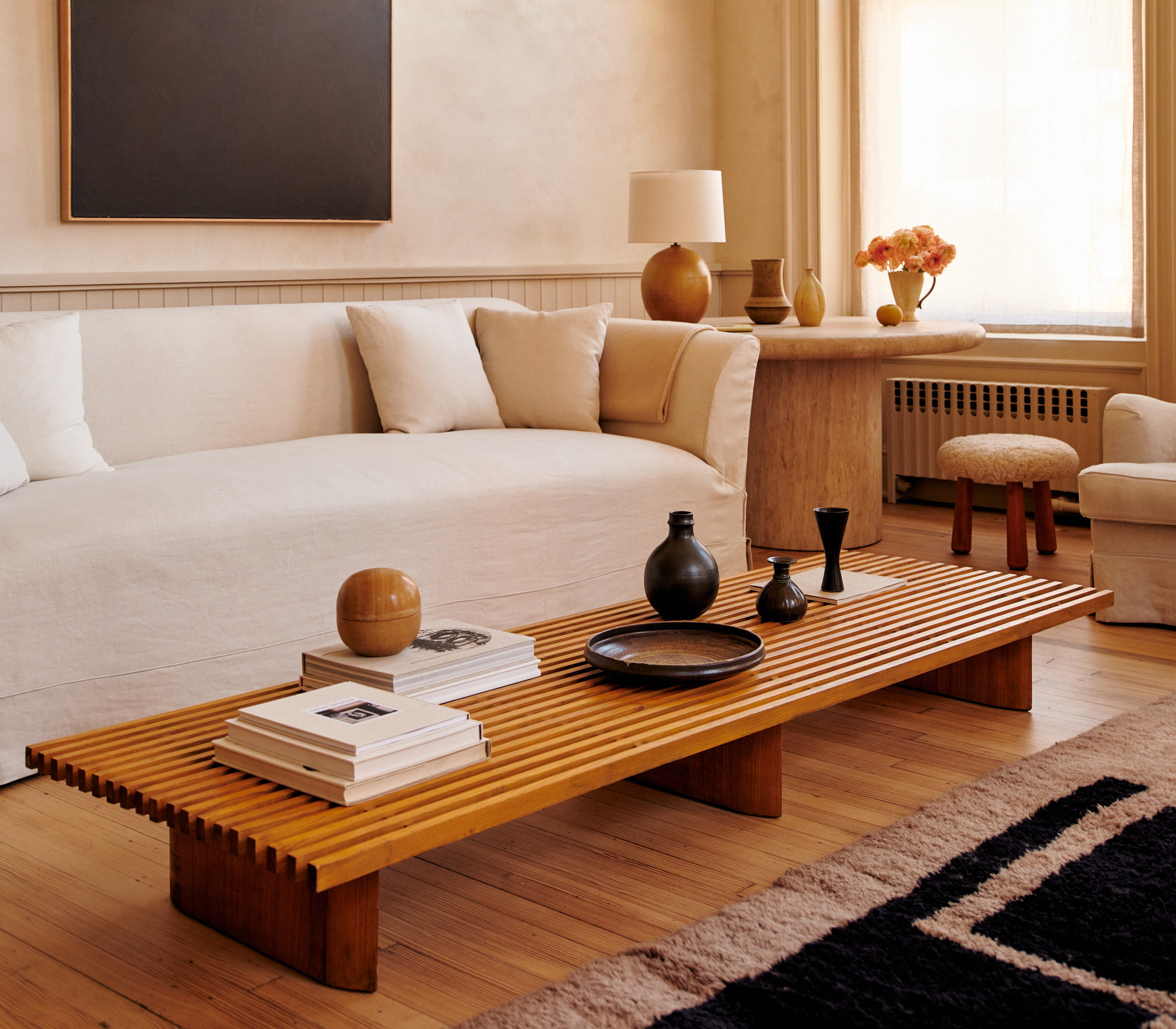 a living room filled with furniture and a painting on the wall