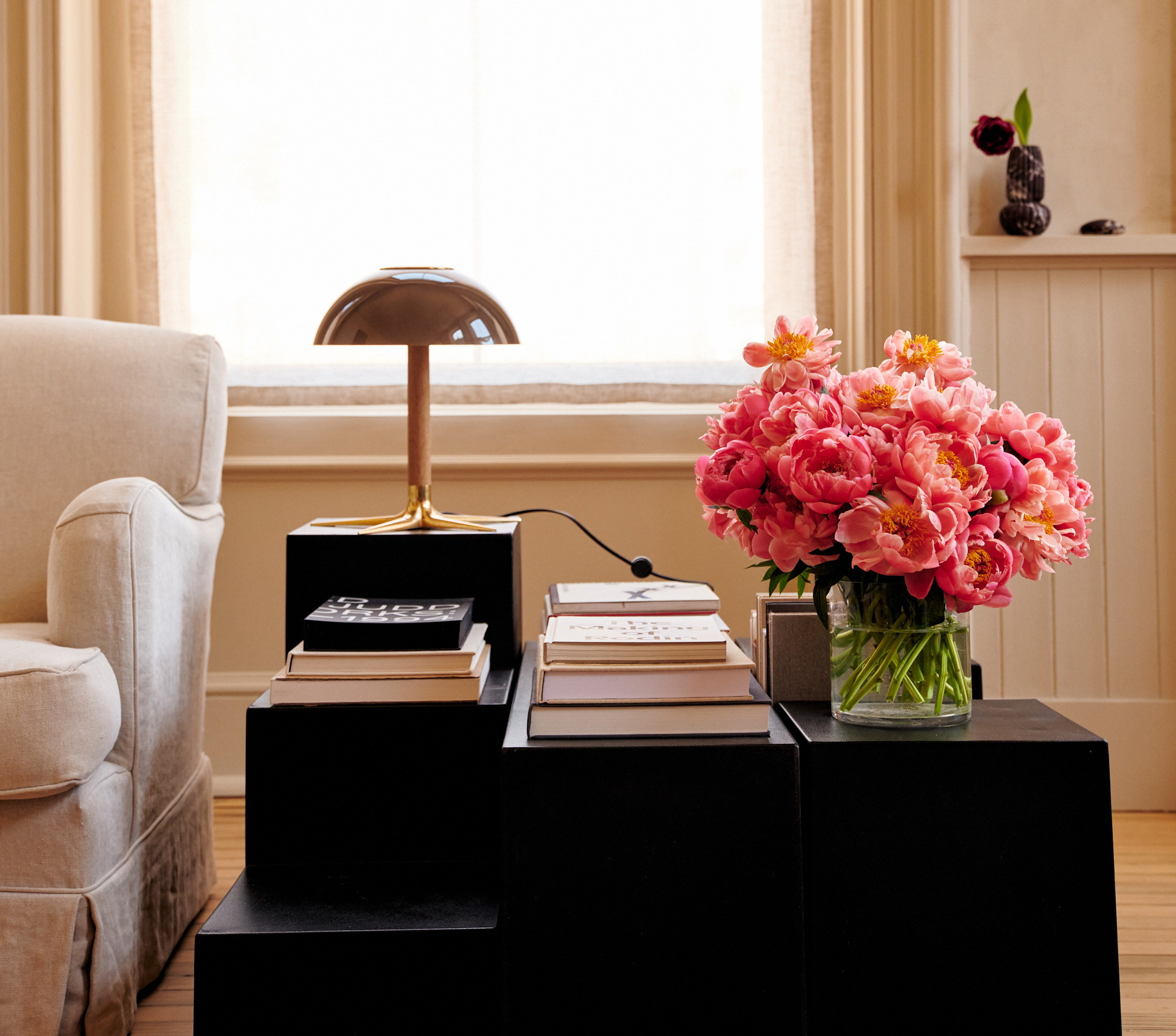 a table with a vase of flowers on top of it