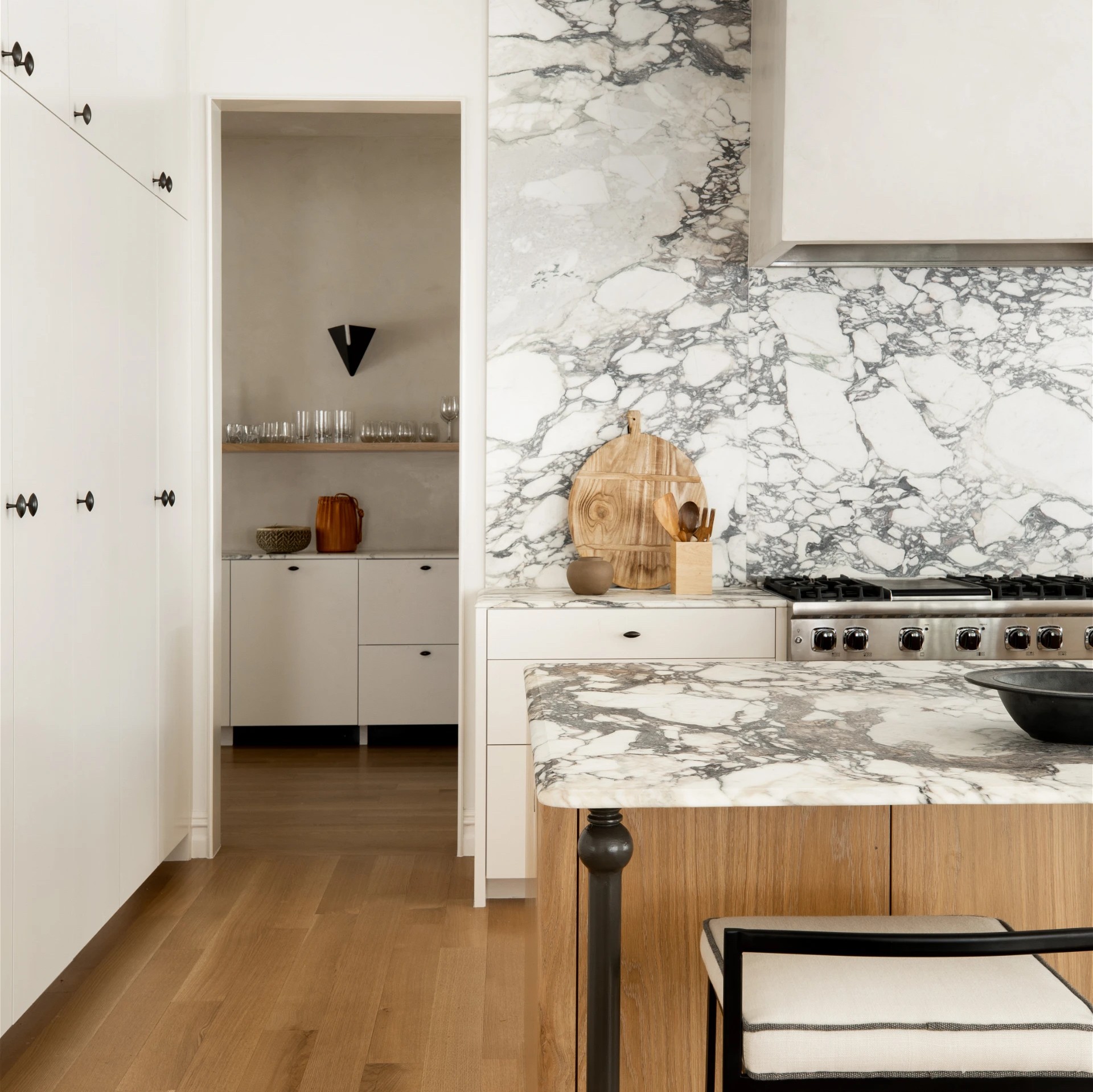 a kitchen with a marble counter top and wooden floors
