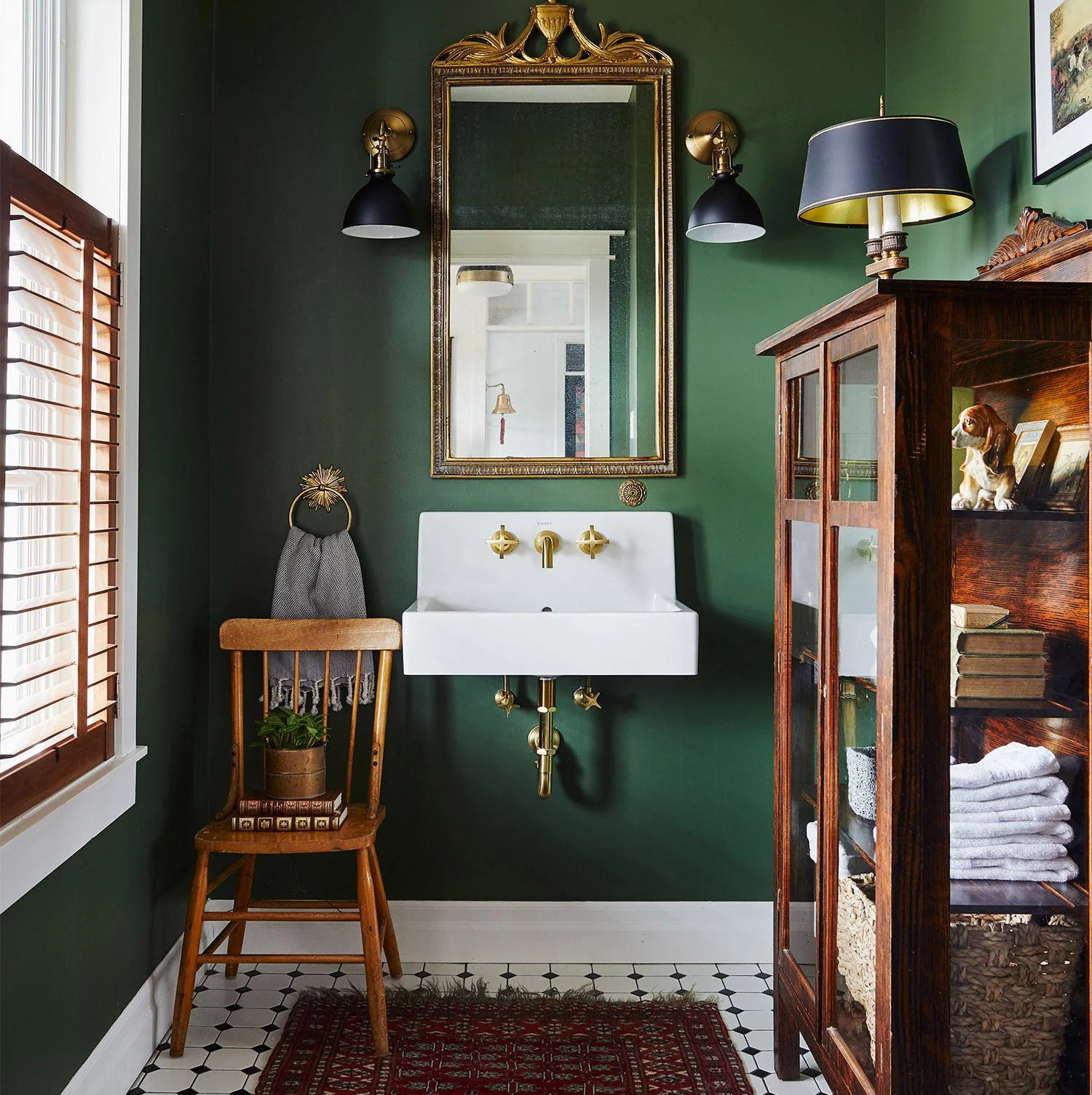 a bathroom with green walls and a red rug