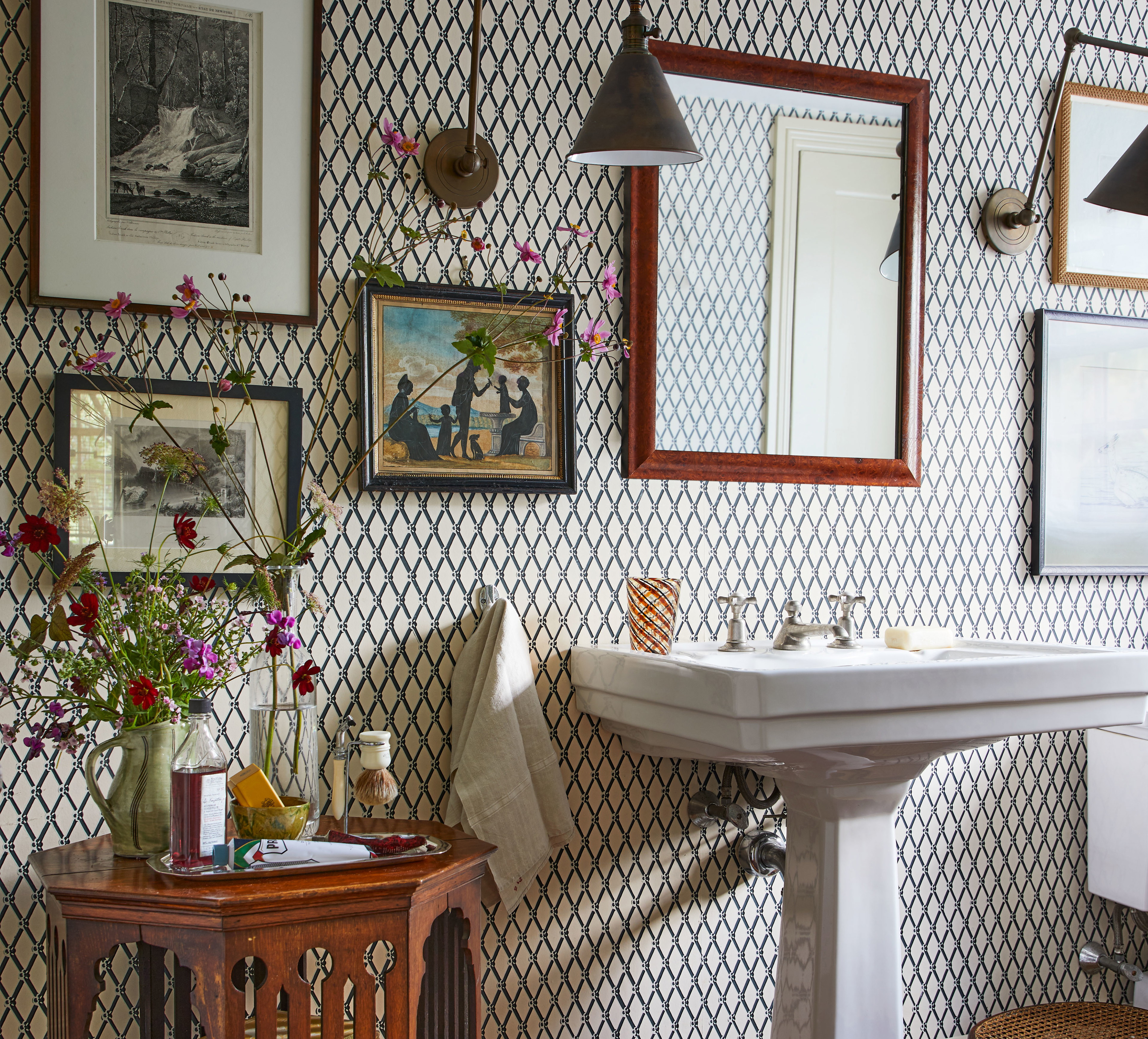 a bathroom with a pedestal sink and a mirror