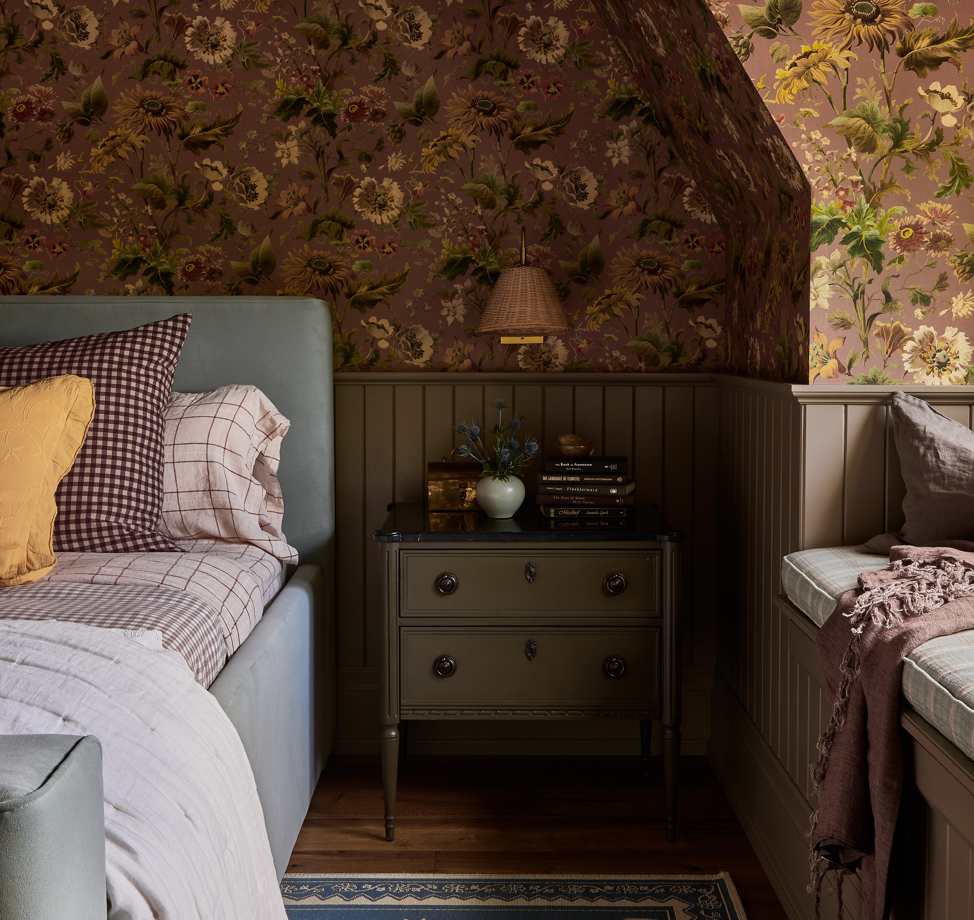 a bedroom with floral wallpaper and a bed