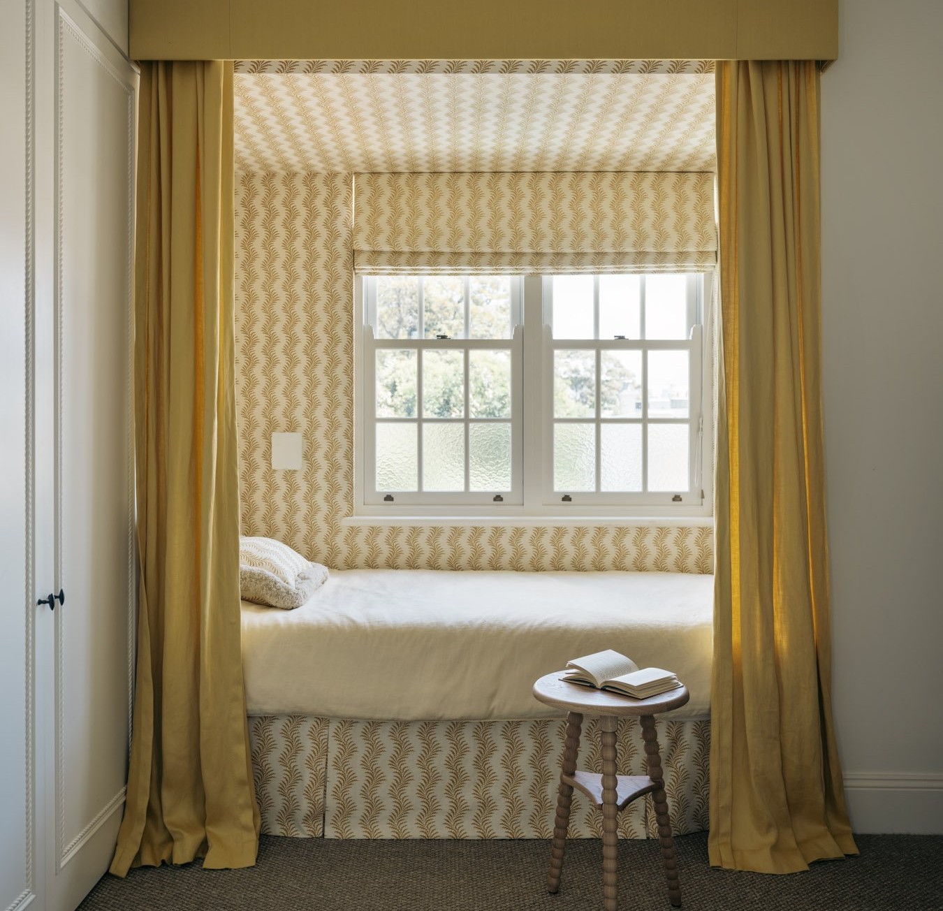 a bedroom with yellow curtains and a white bed