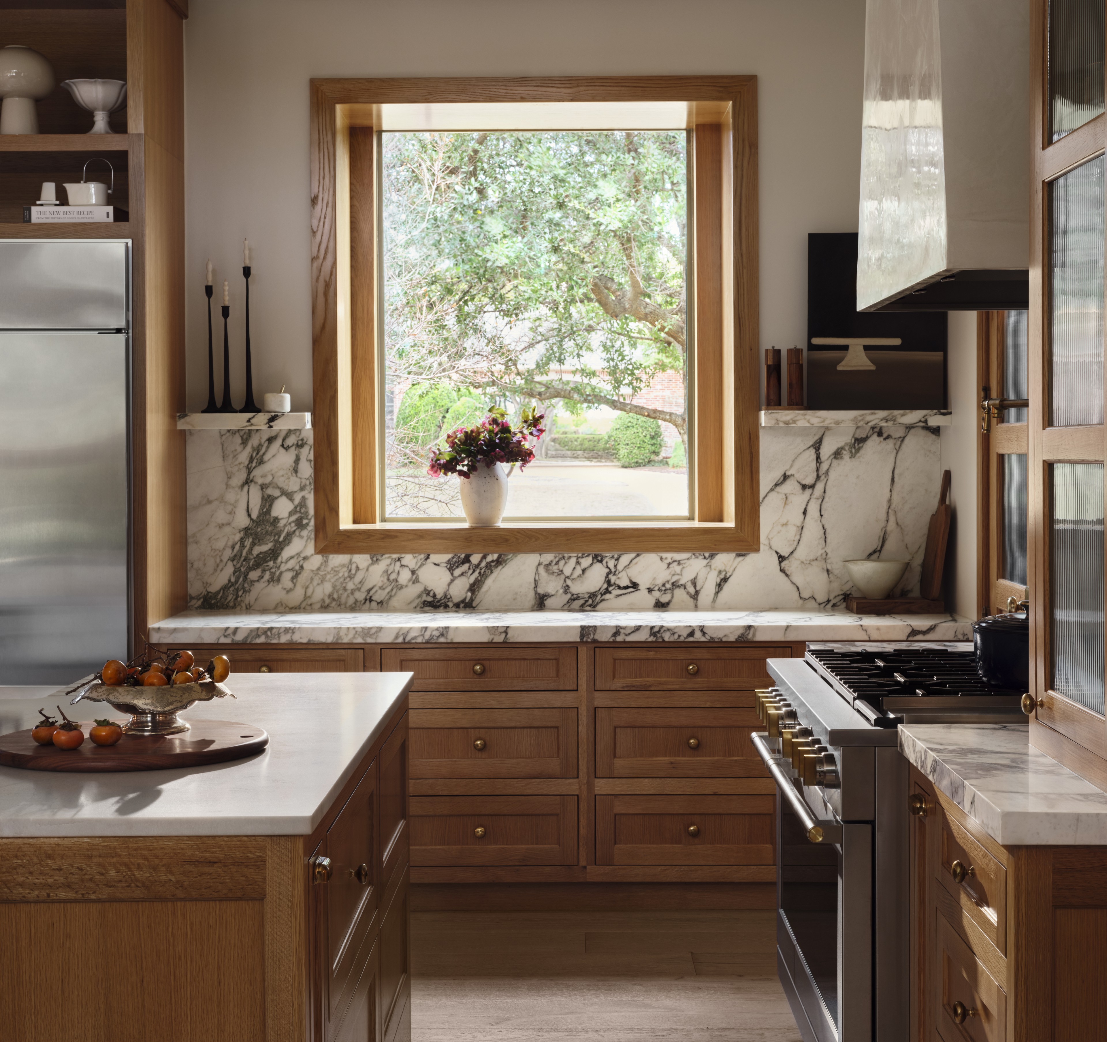 a kitchen with a stove top oven sitting under a window