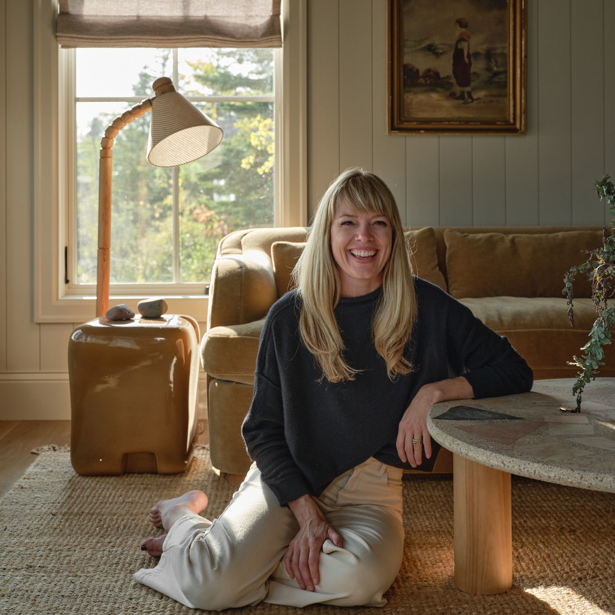 a woman sitting on the floor in a living room