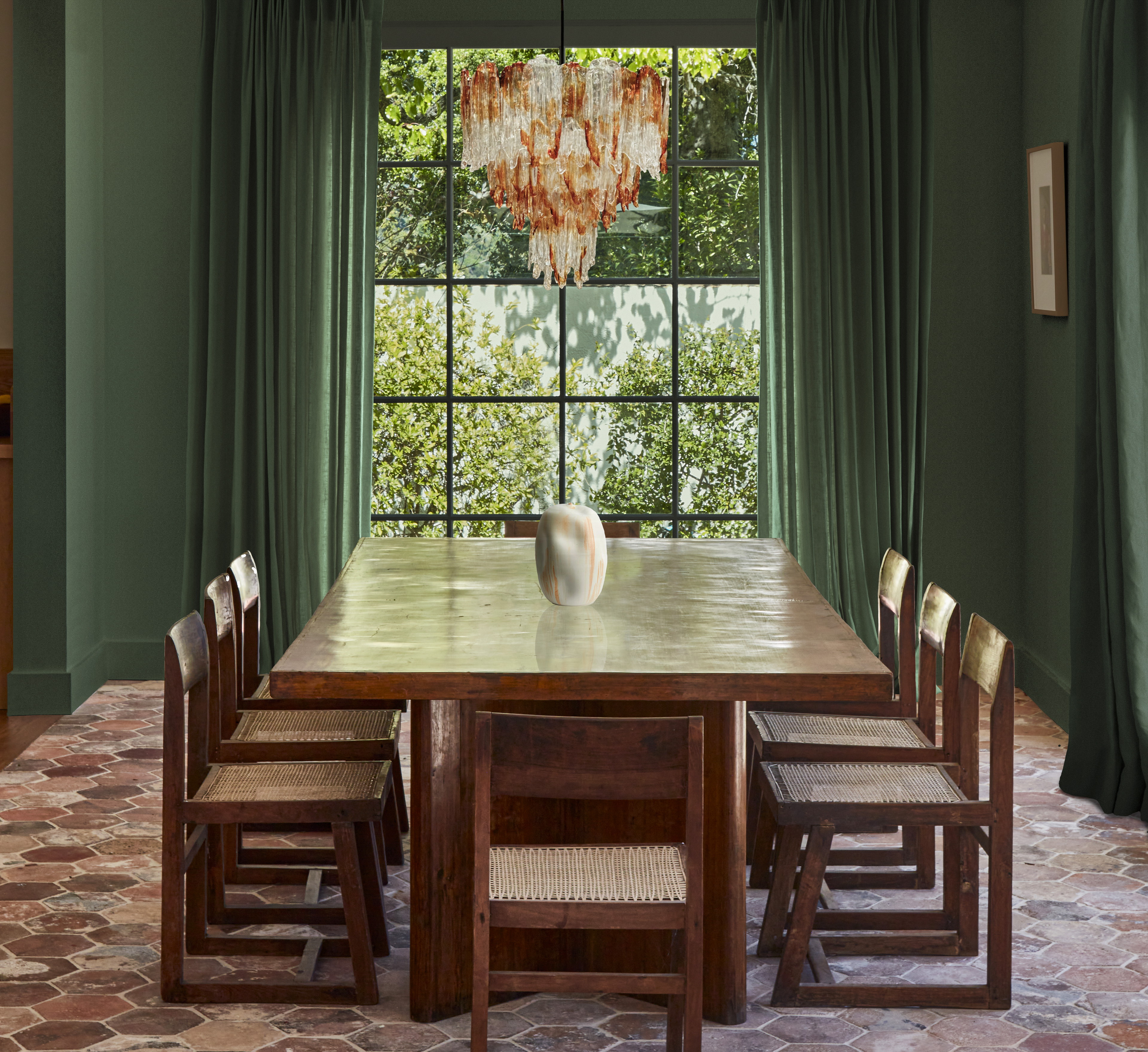 a dining room with a large wooden table and chairs