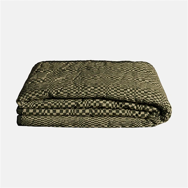 a green and black checkered blanket on a white background