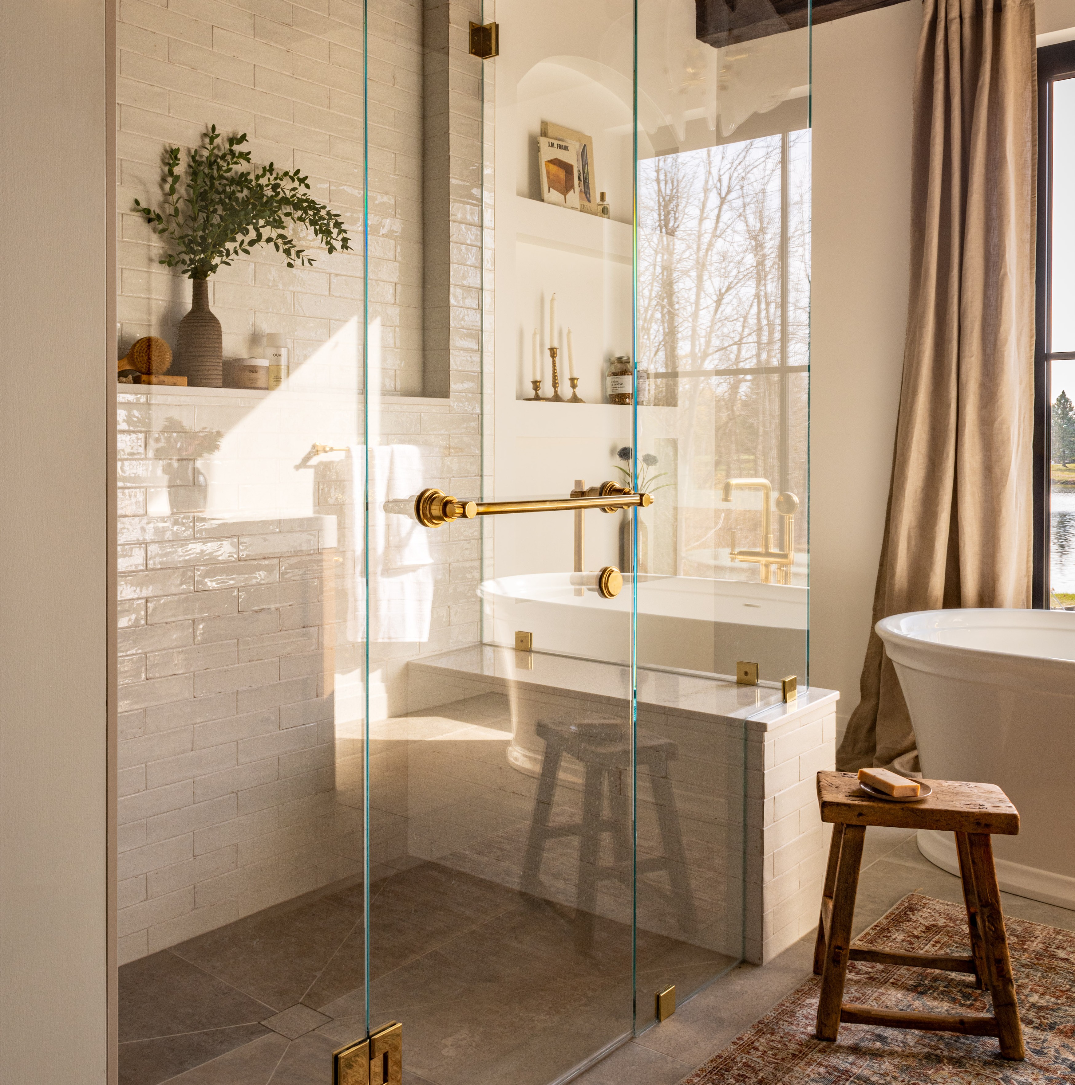 a bathroom with a tub and a wooden stool