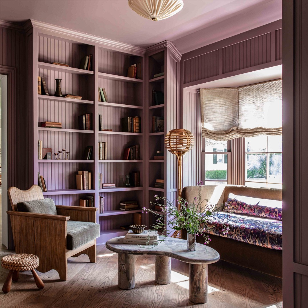 a living room filled with furniture and bookshelves