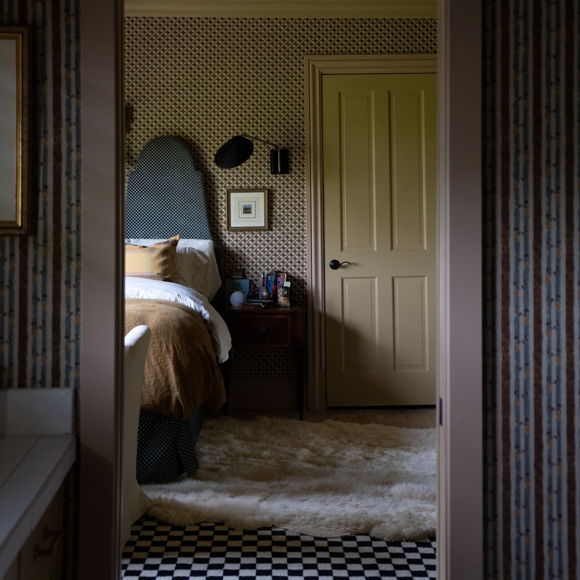 a bedroom with a bed and a checkered floor