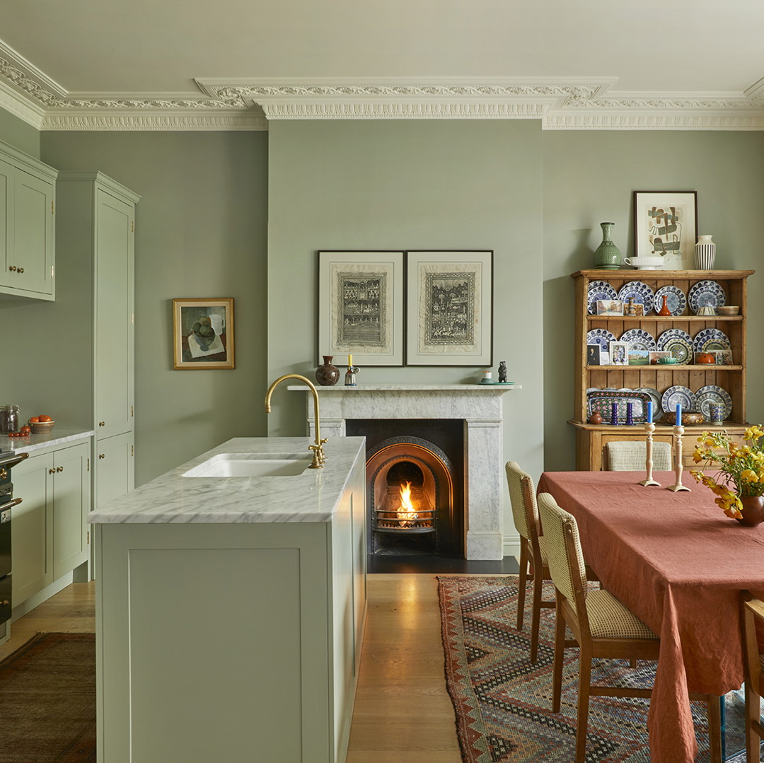 a kitchen with a stove and a dining room table