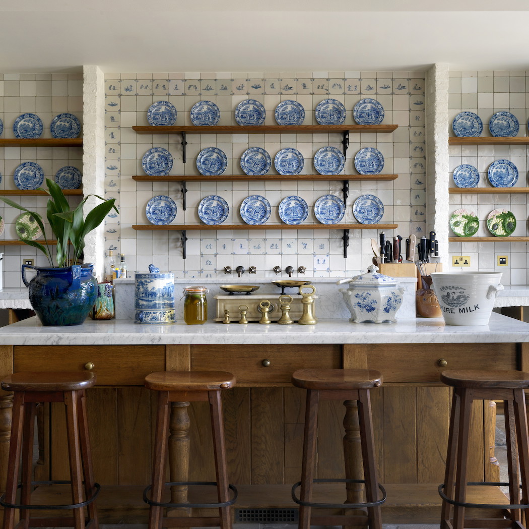 a kitchen filled with lots of blue and white plates