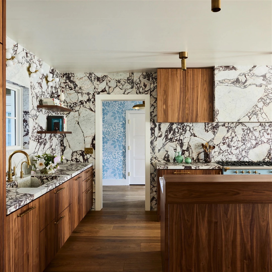 a kitchen with marble counter tops and wooden cabinets