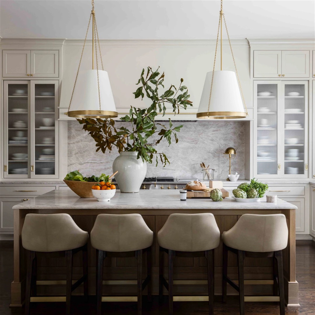 a kitchen with a marble counter top and white chairs