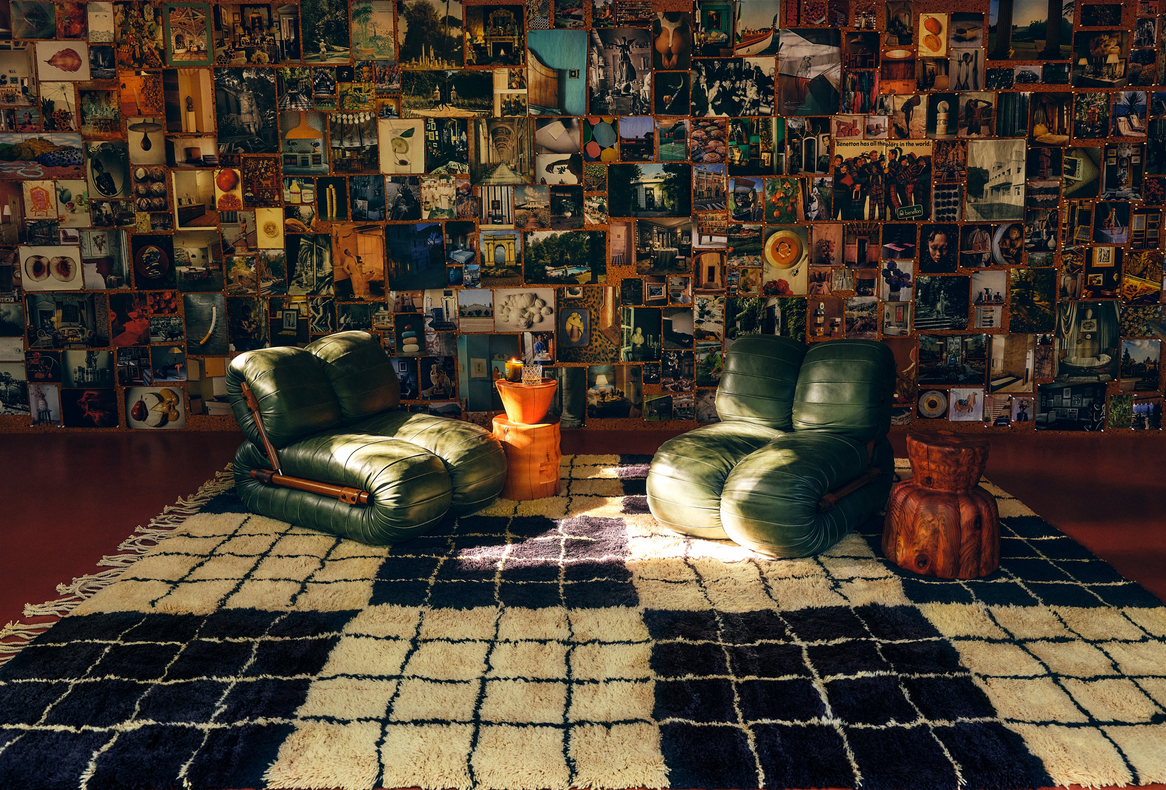 a living room filled with furniture and a wall covered in pictures