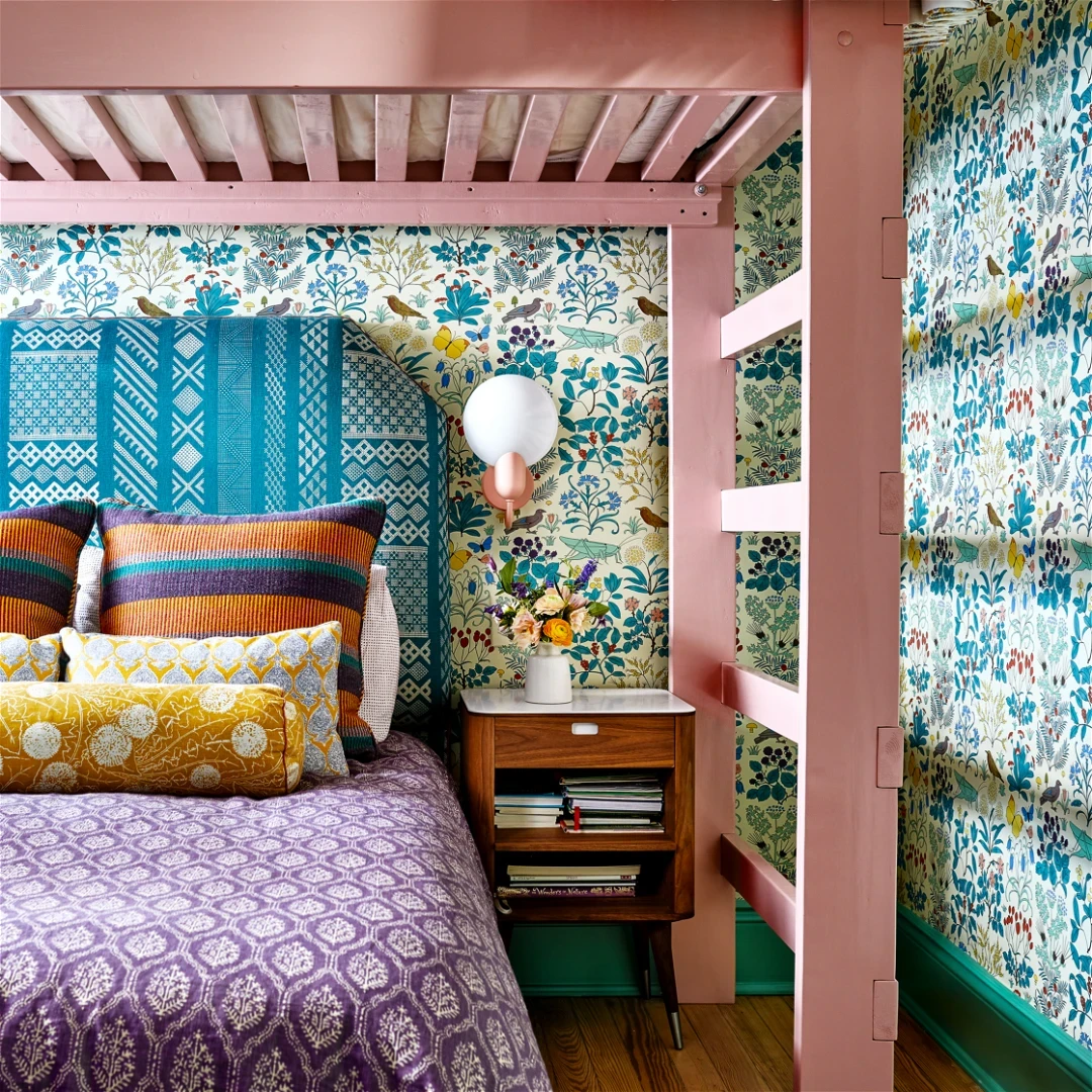 a bedroom with a bed and colorful wallpaper