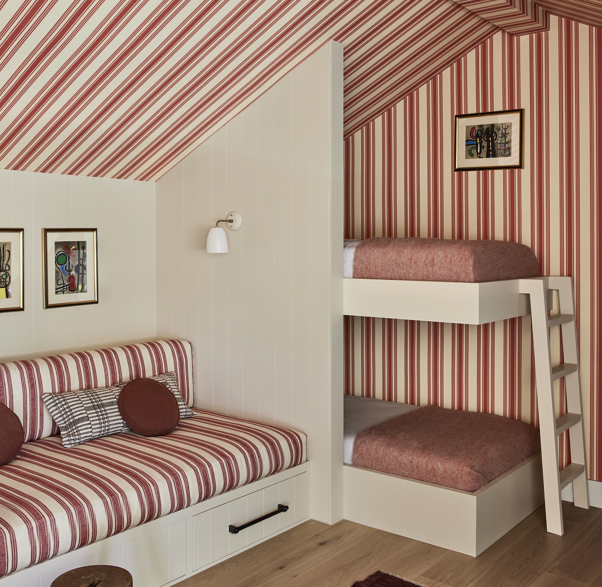 a red and white striped room with bunk beds