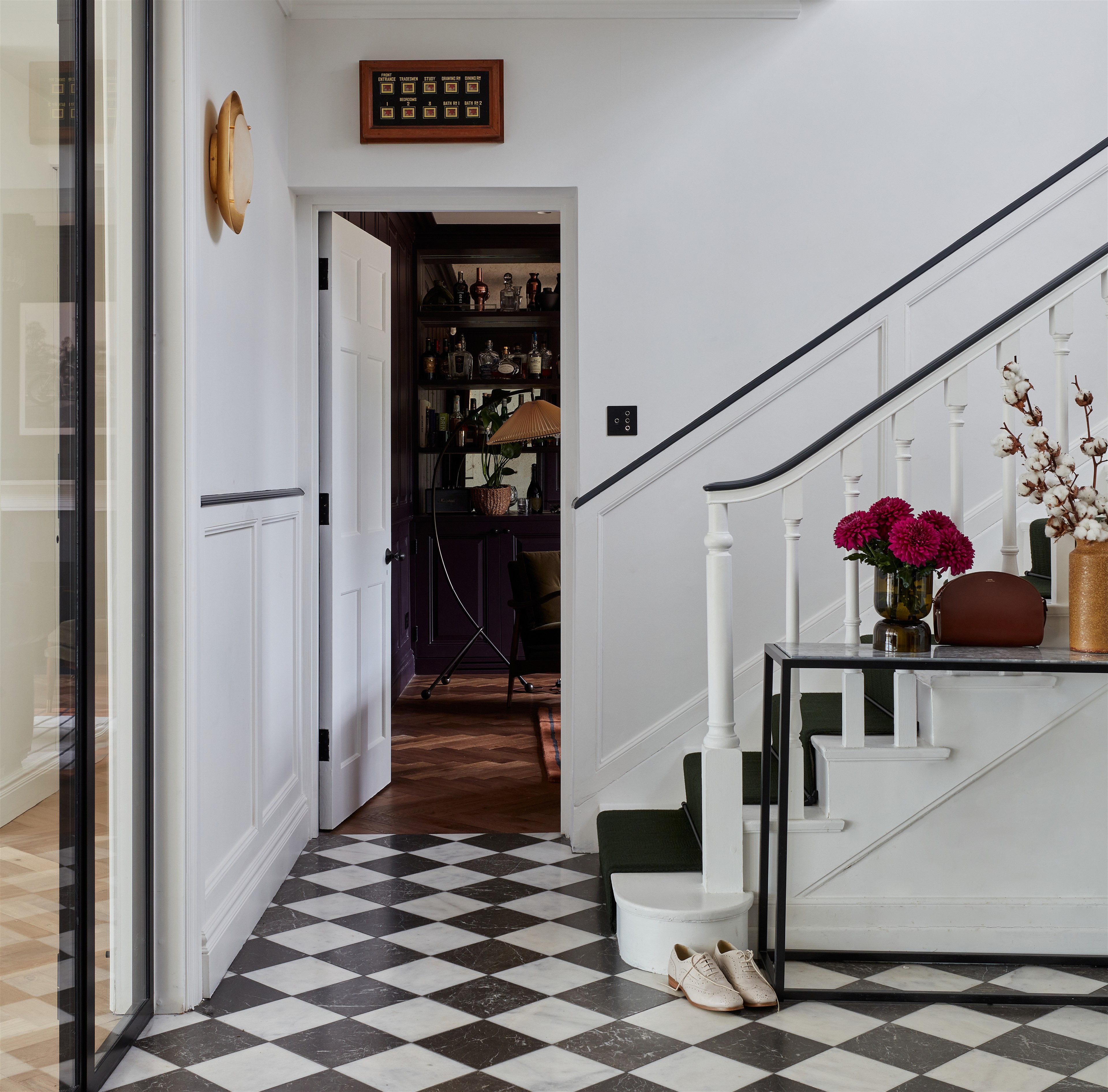 a hallway with a checkered floor and a black and white checkered floor