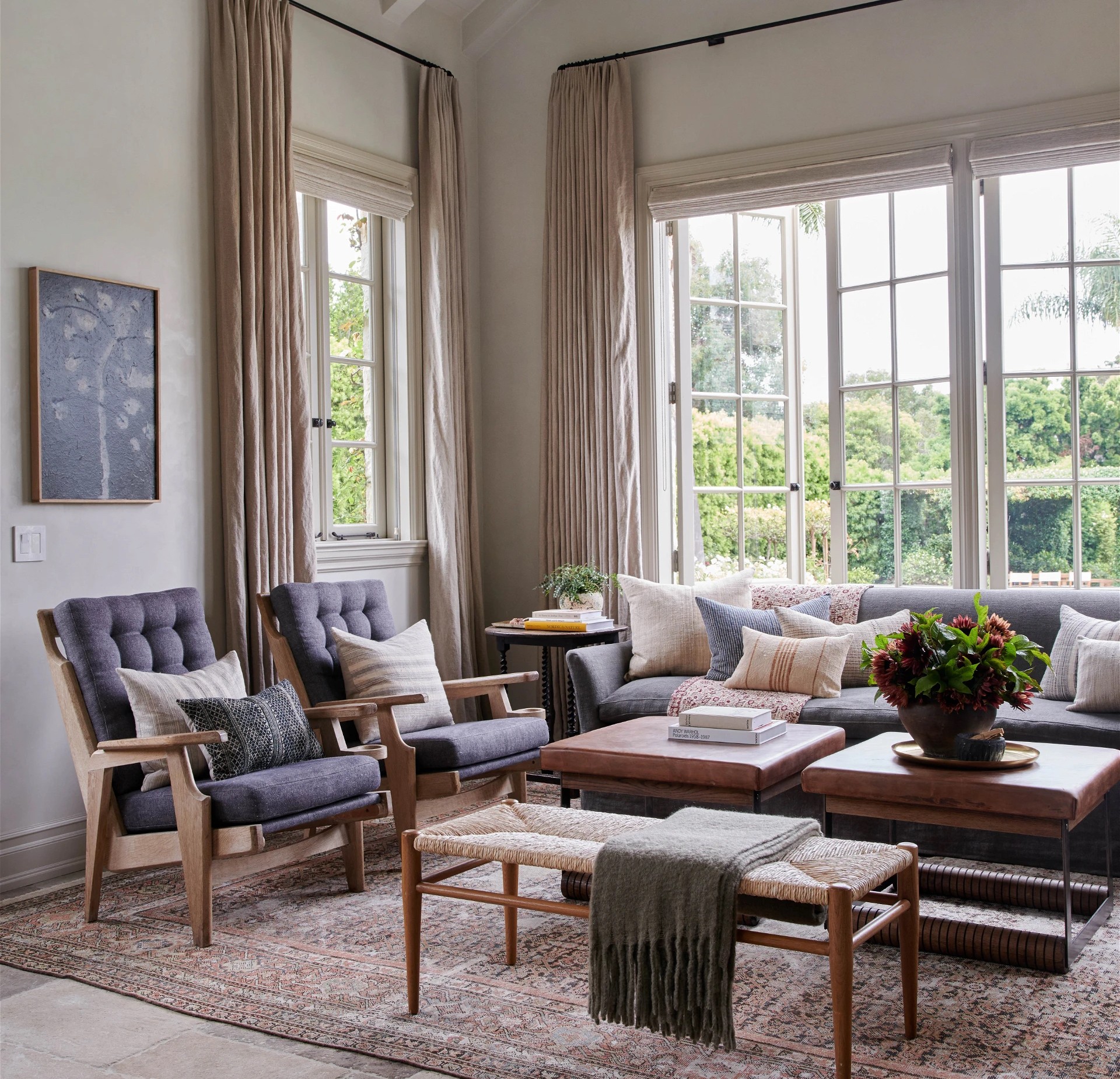 a living room filled with furniture and large windows
