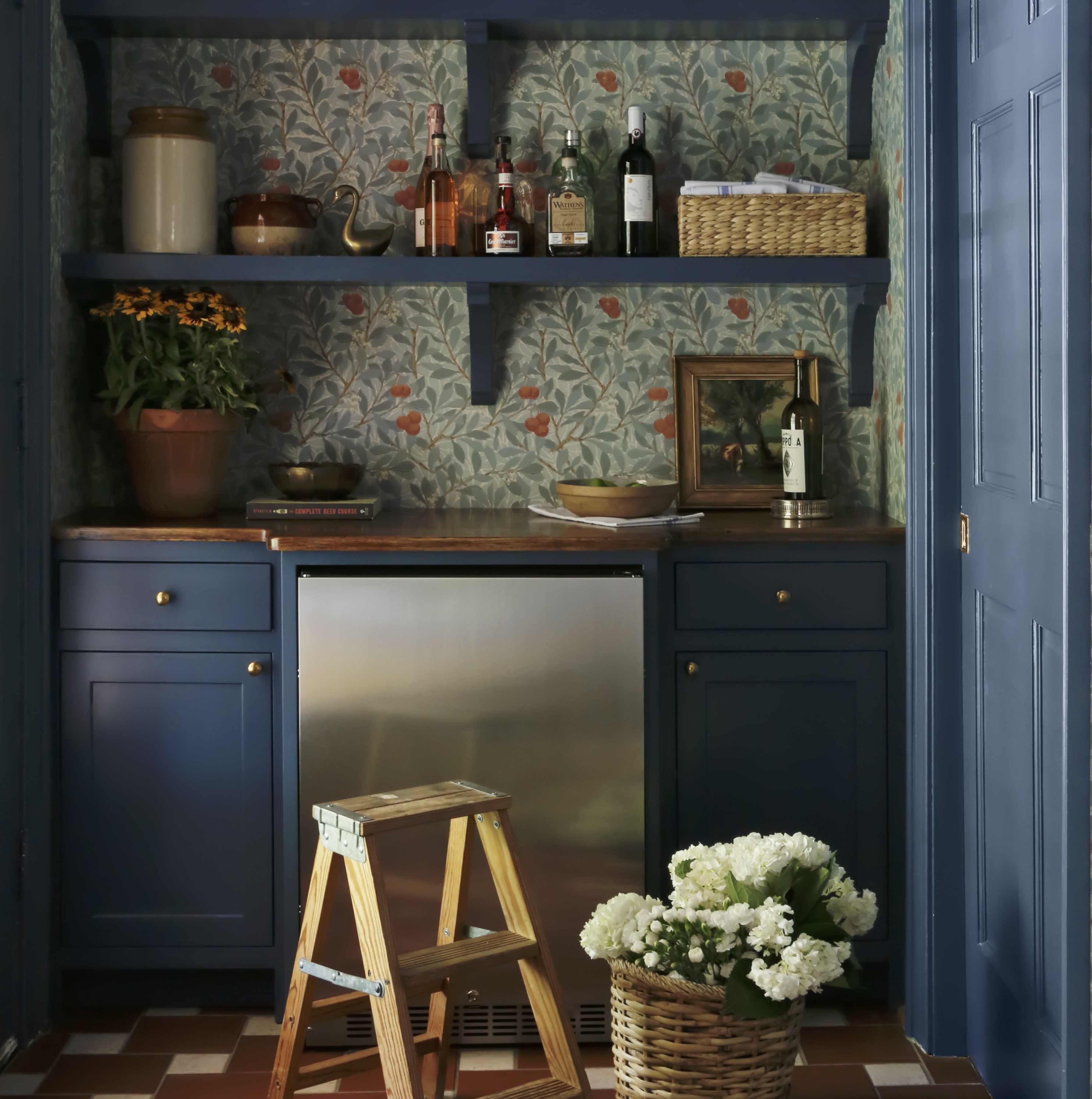 a kitchen with blue cabinets and a checkered floor