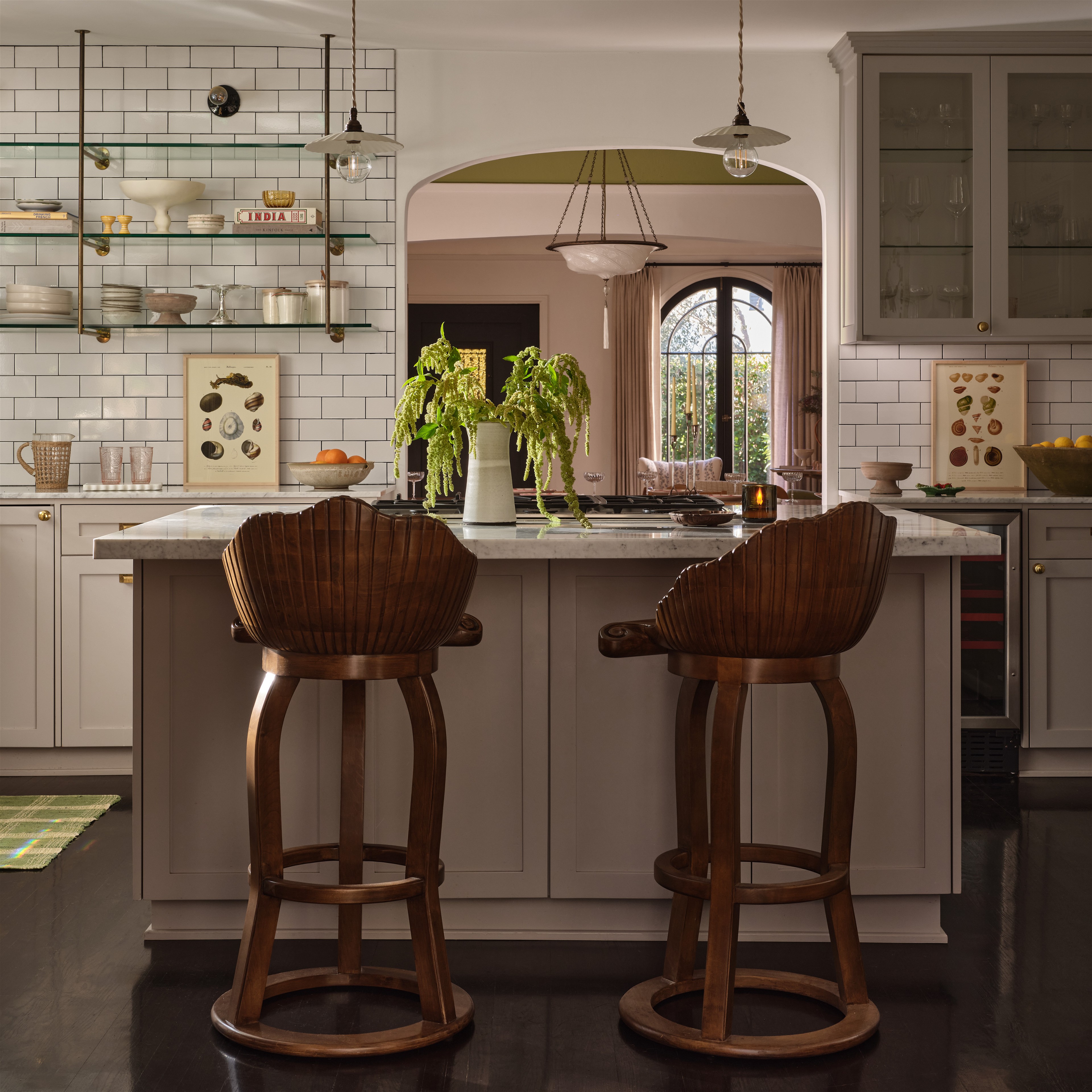 a kitchen with two stools in front of a counter