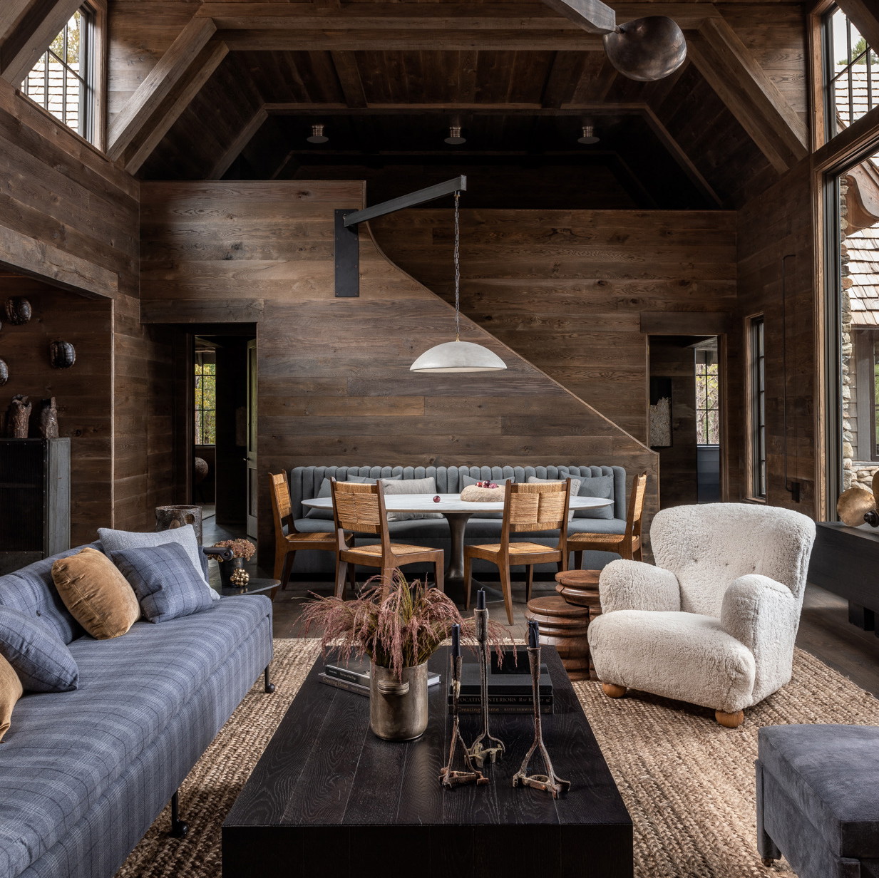 a living room filled with furniture and wooden walls