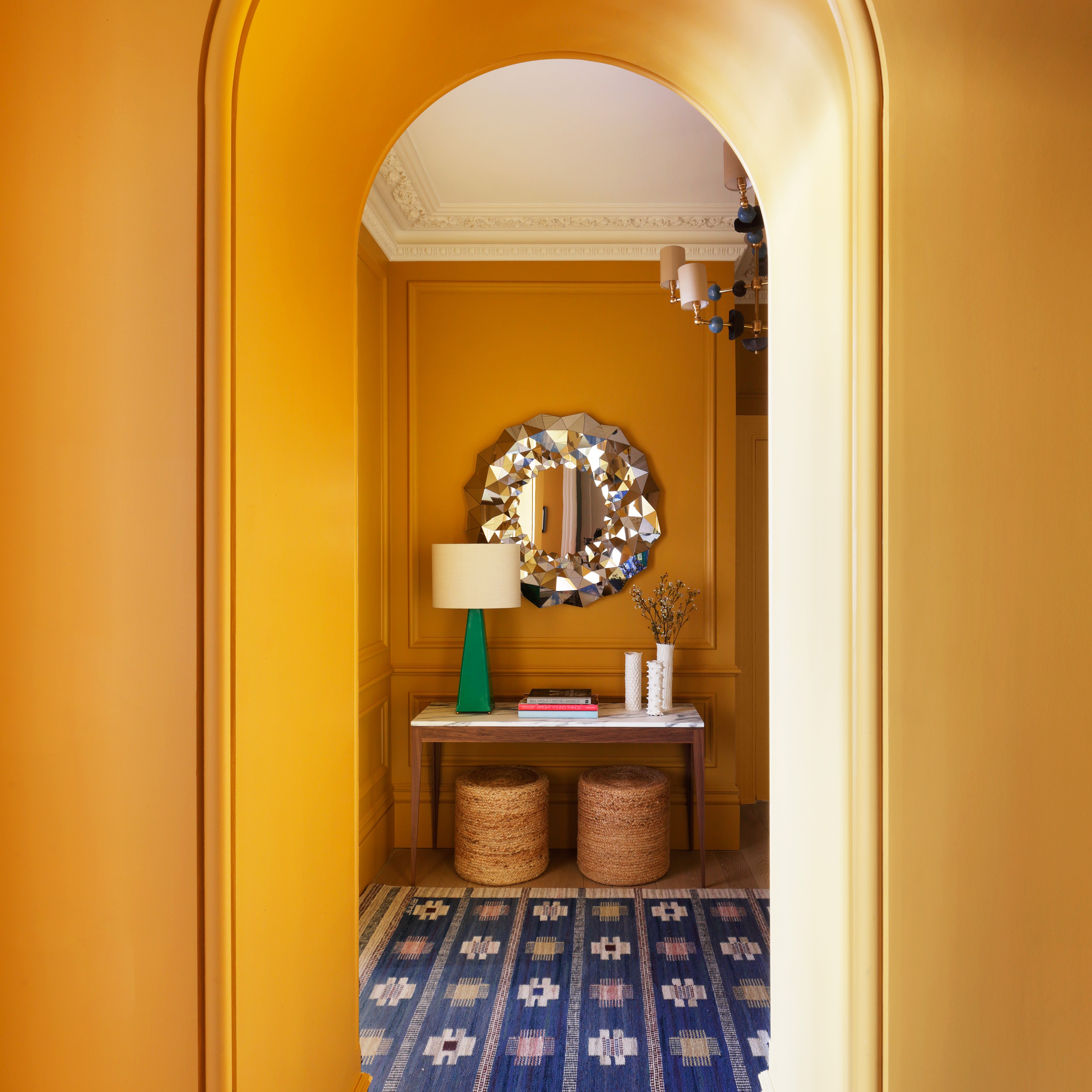 a hallway with yellow walls and a blue and white floor