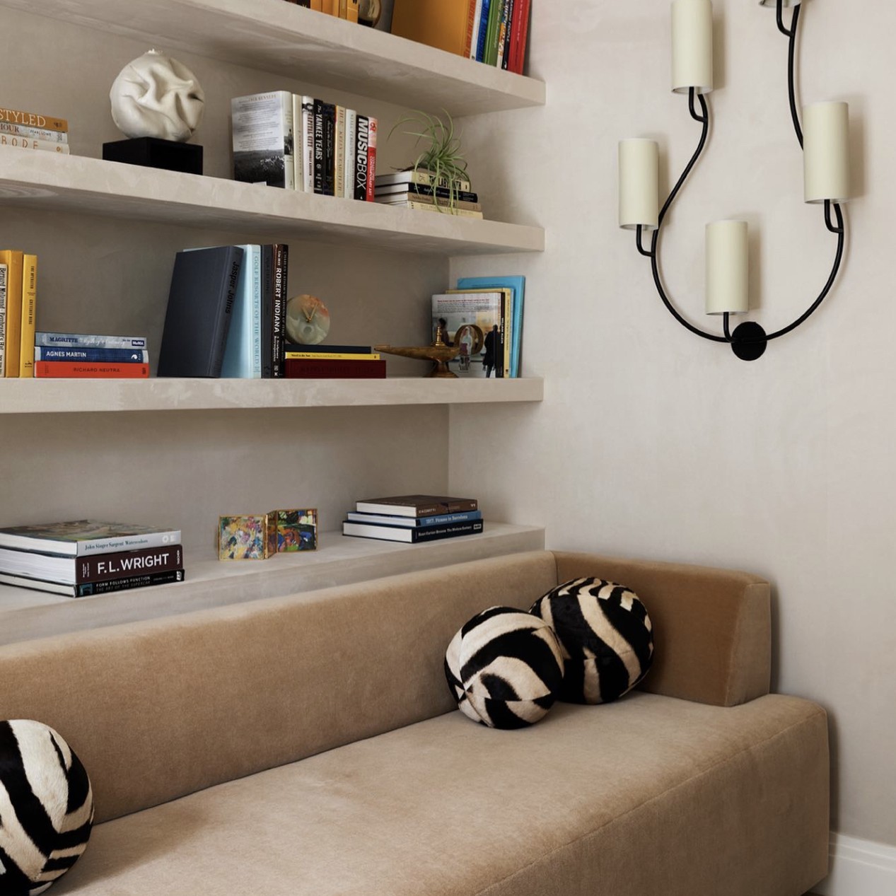 a living room with a couch and a book shelf