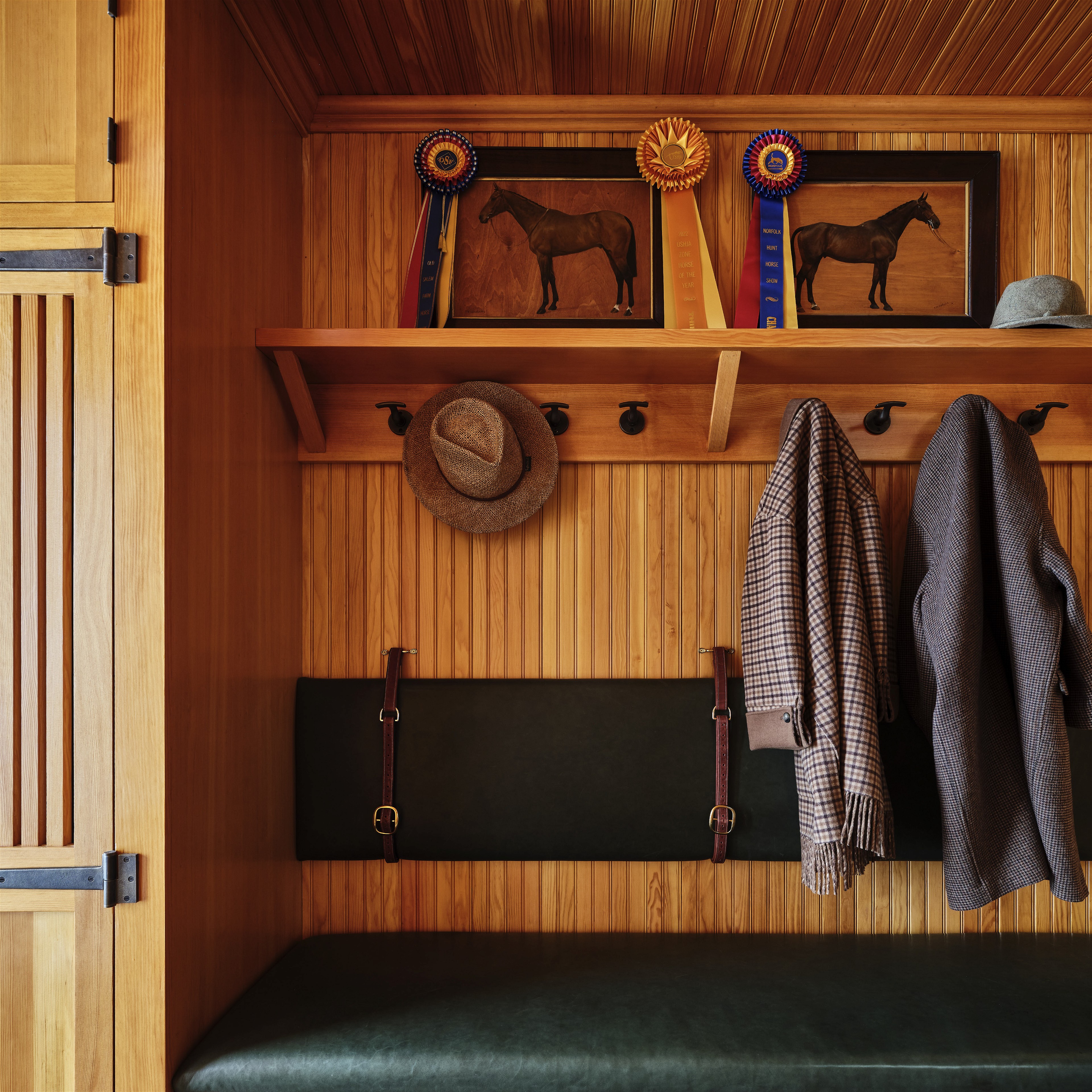 a bench and coat rack in a wooden room