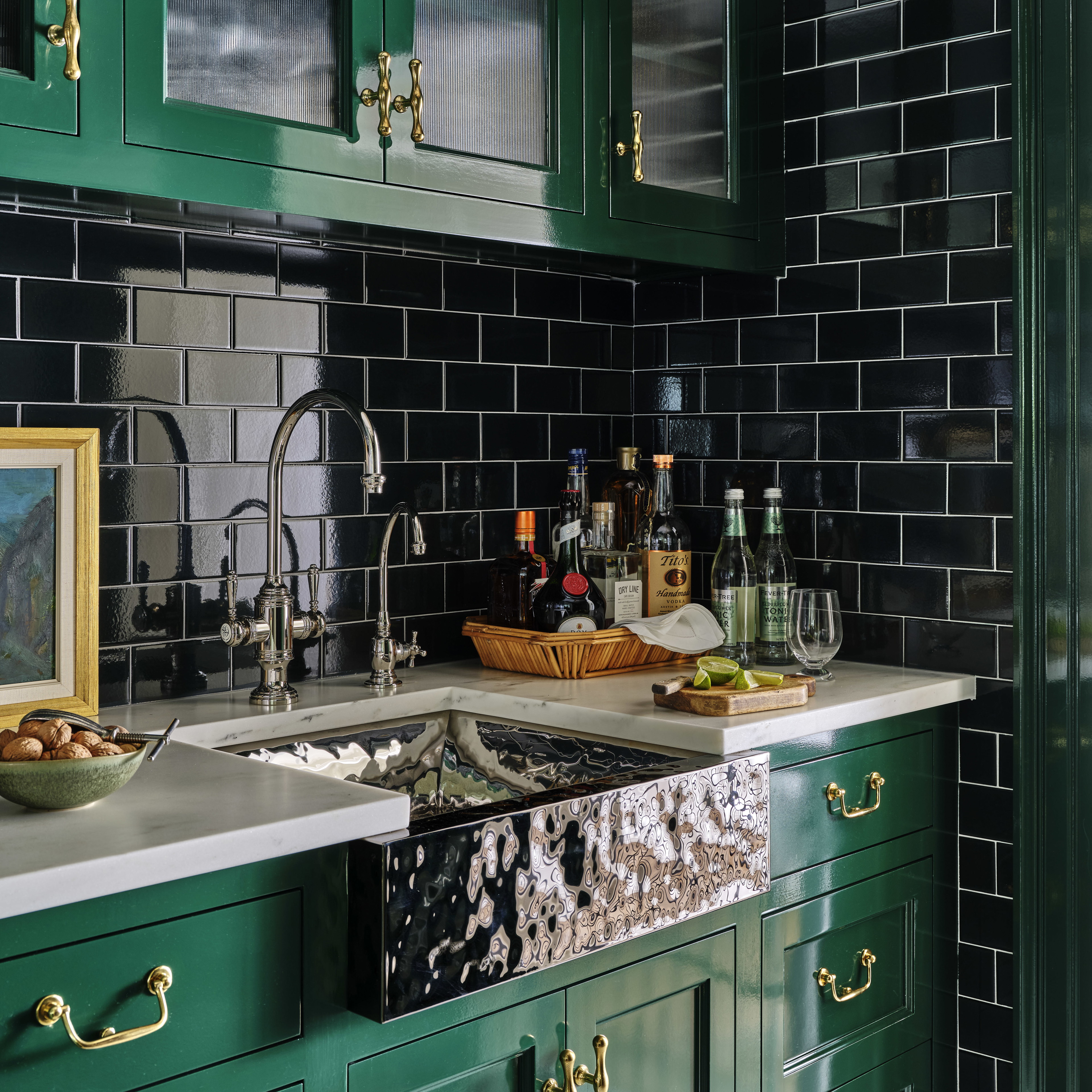 a kitchen with green cabinets and a sink