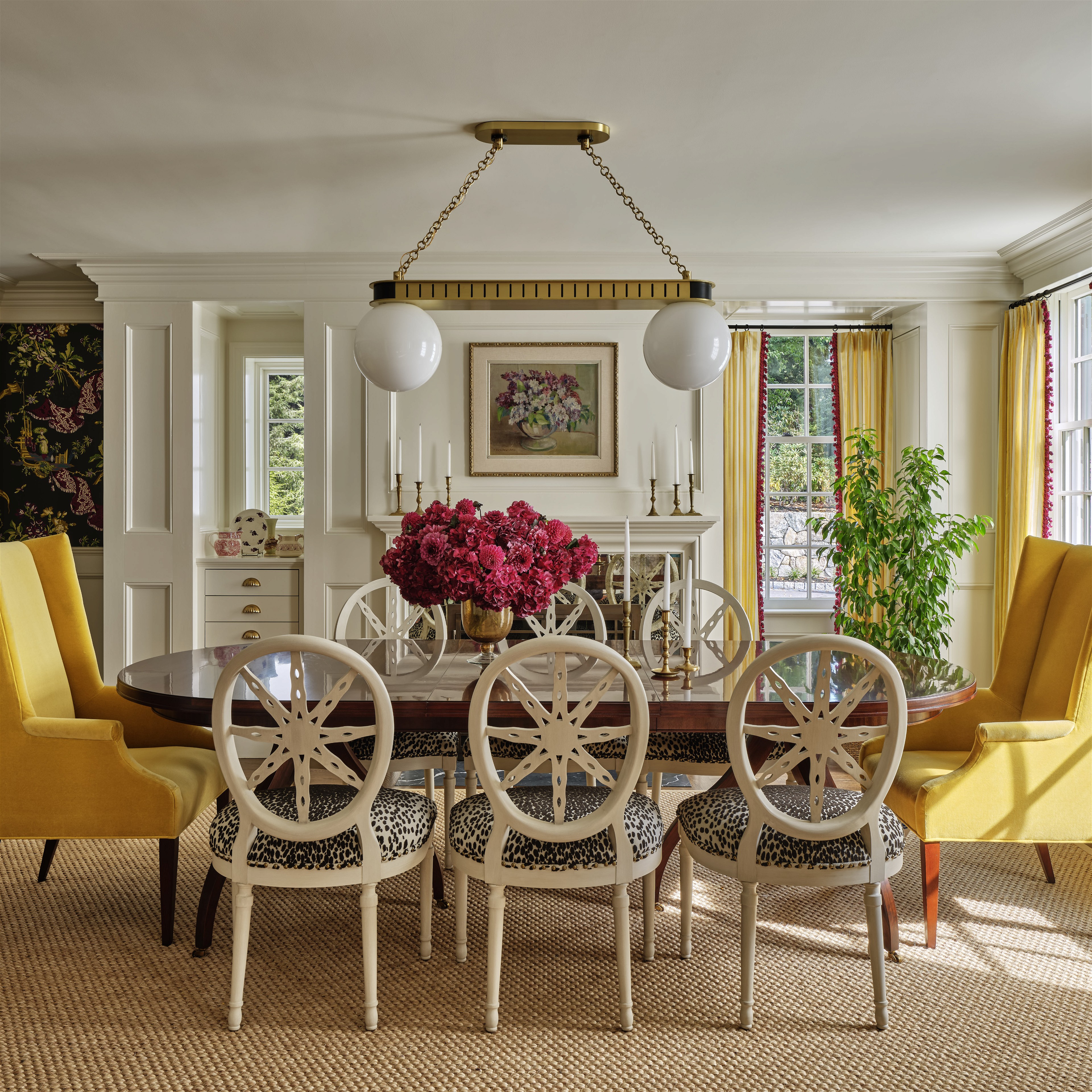a dining room with yellow chairs and a table