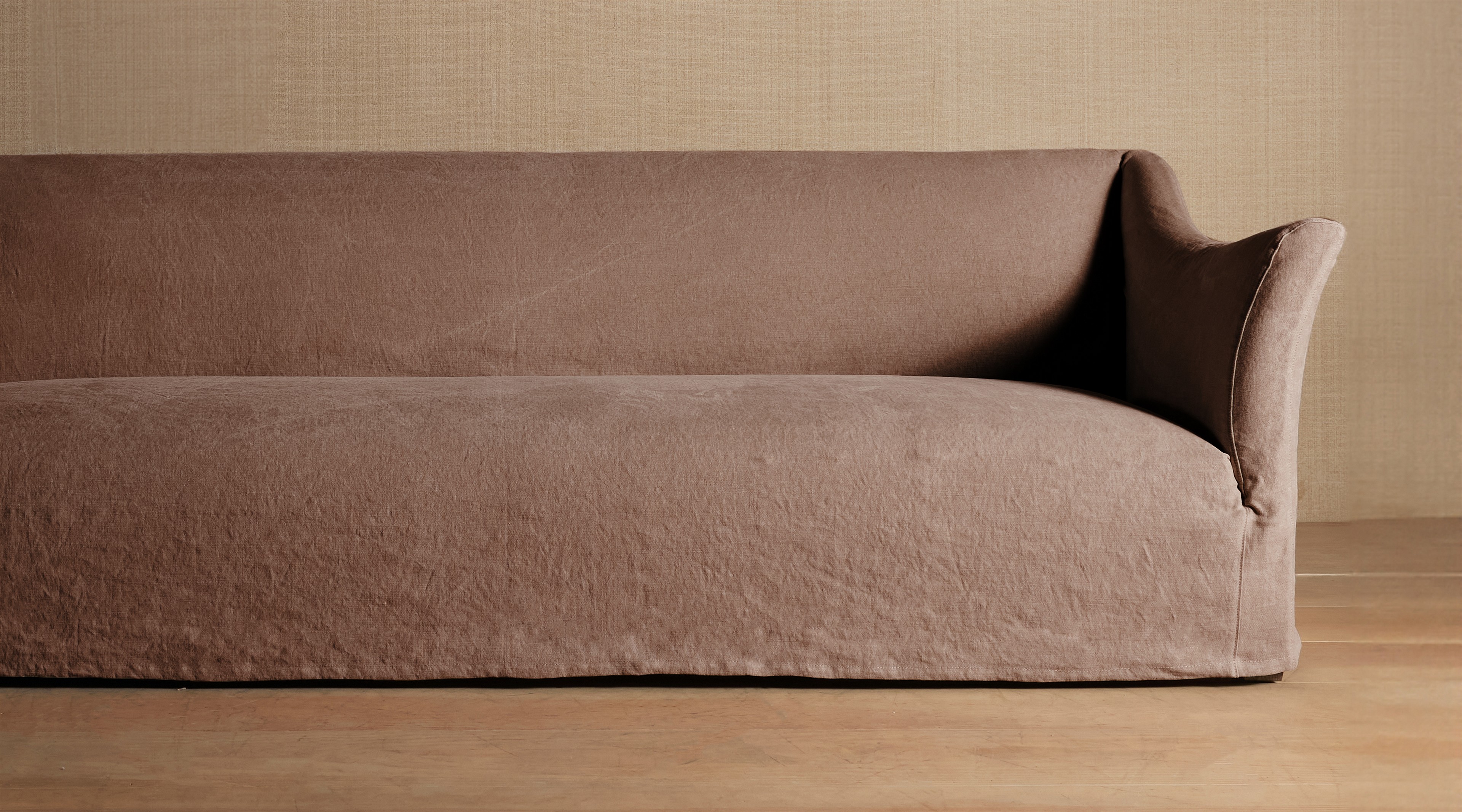 a brown couch sitting on top of a wooden floor