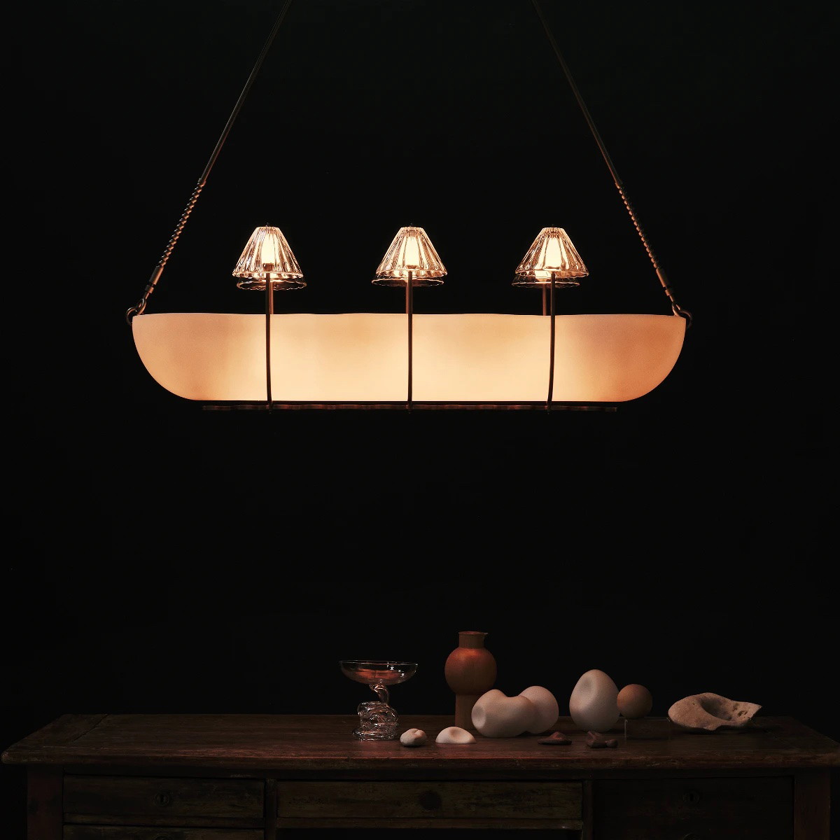 a light fixture hanging over a wooden table