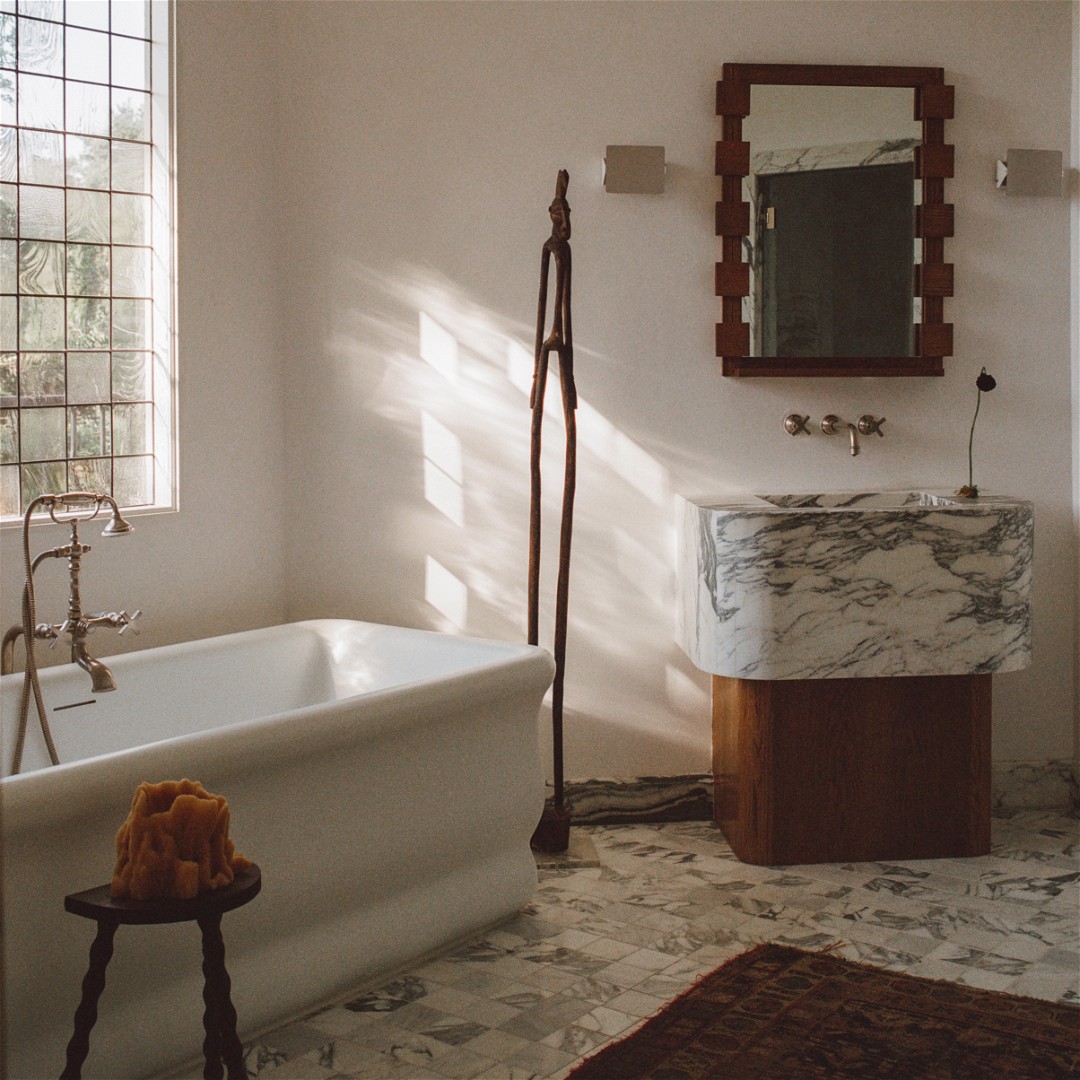 a white bath tub sitting next to a window