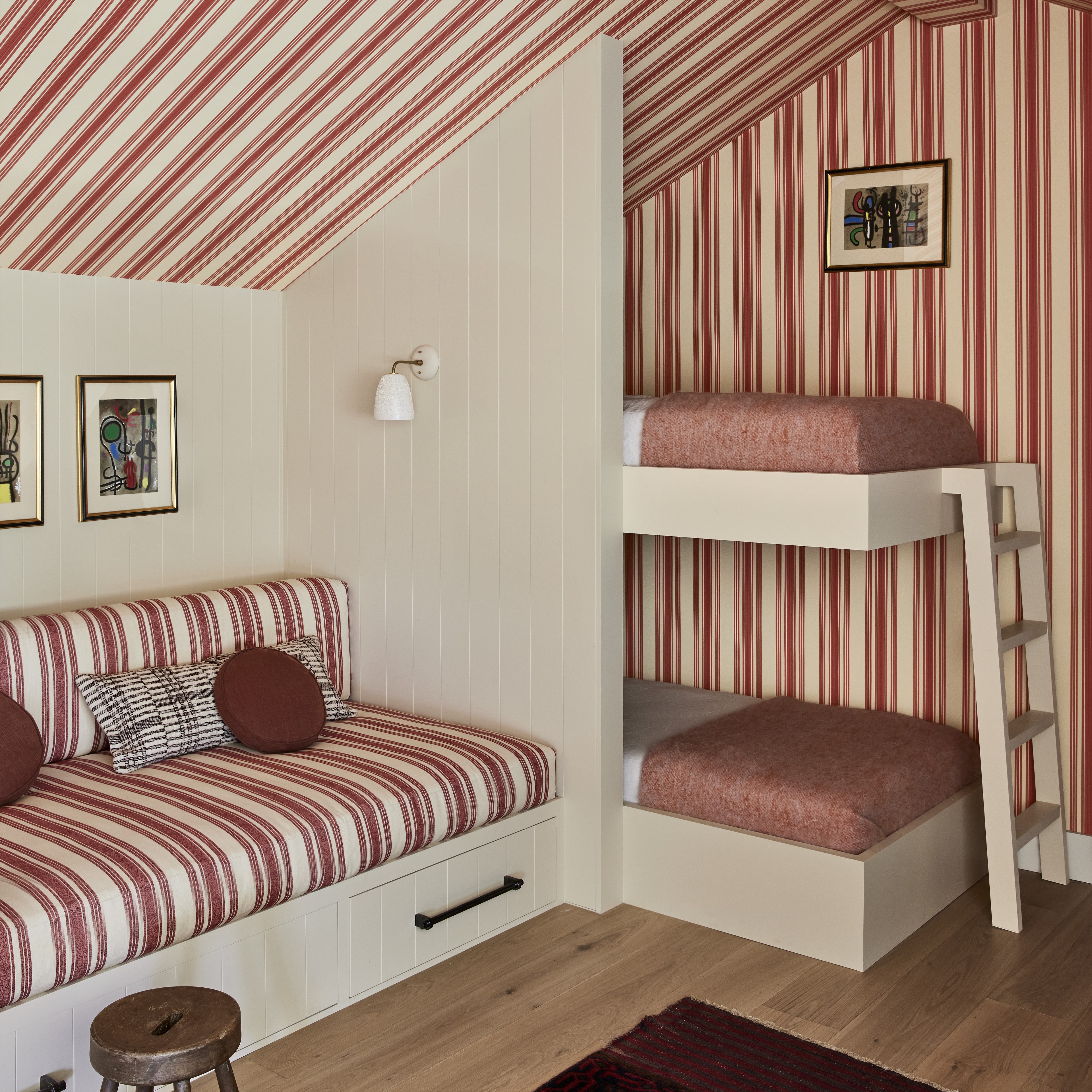 a room with a bunk bed and a striped wall